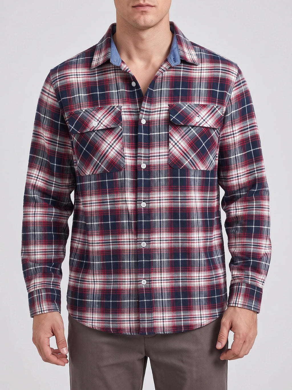 Front studio view of a model wearing a Red plaid flannel shirt with long sleeves, button front, and two chest pockets.