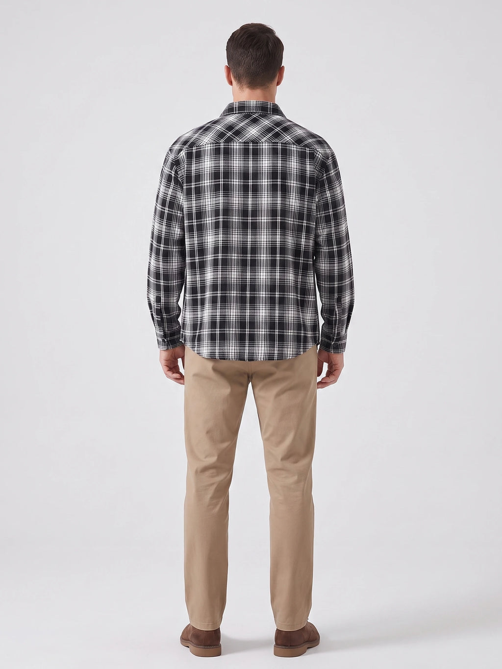 Rear studio view of a model wearing a Black plaid long-sleeve Flannel Shirt.