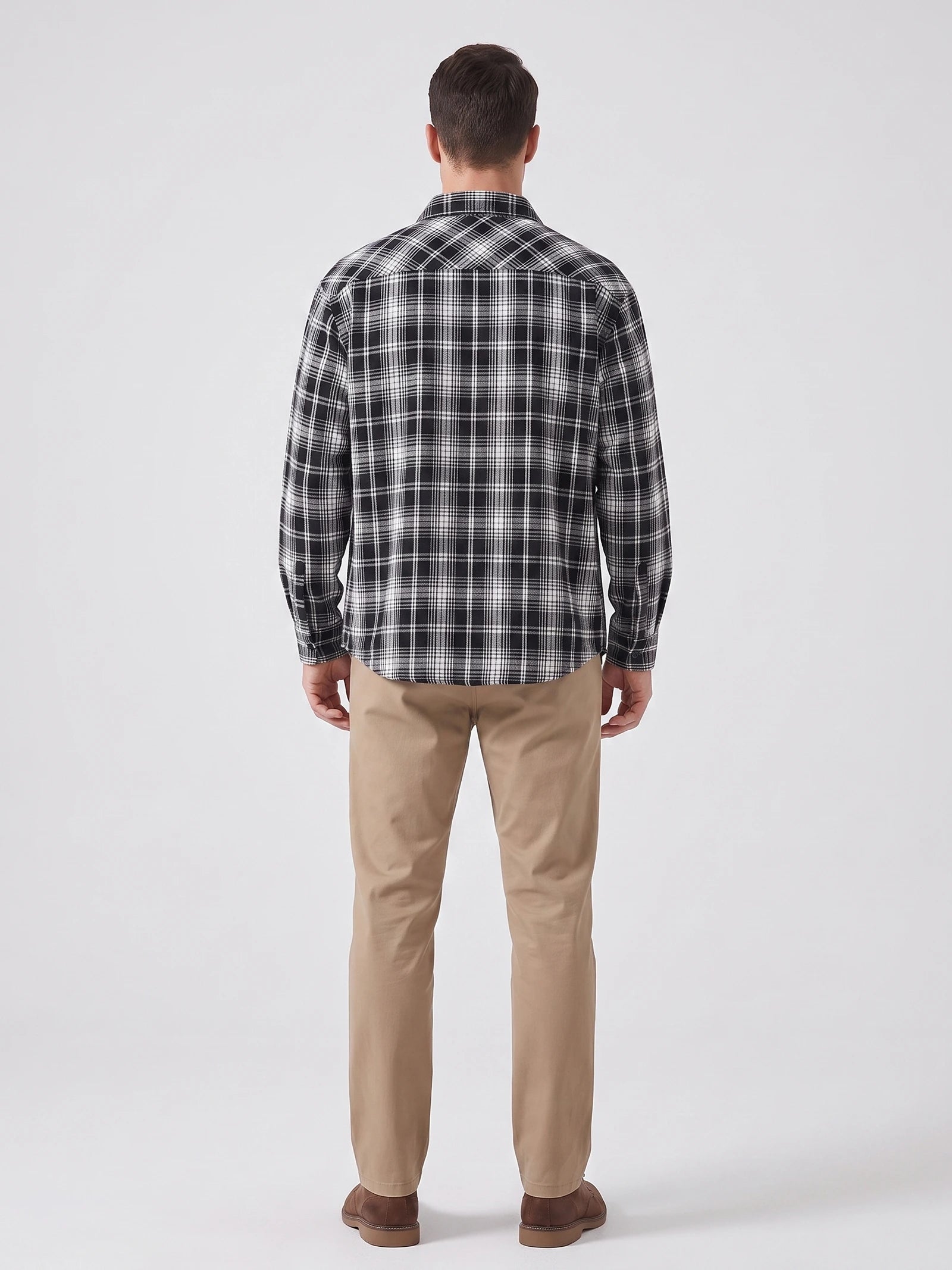 Rear studio view of a model wearing a Black plaid long-sleeve Flannel Shirt.