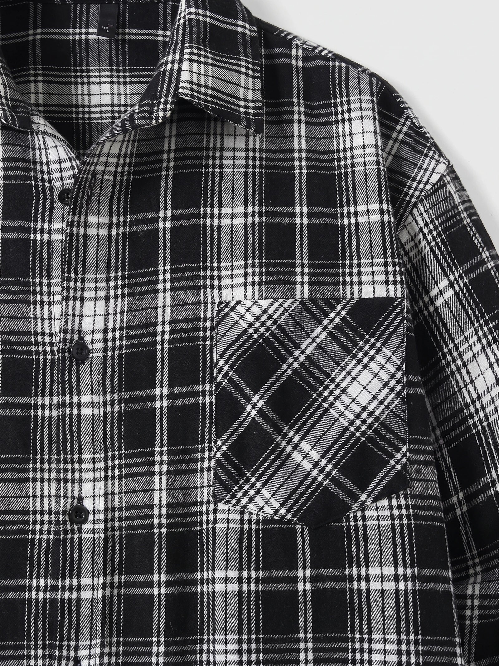 Close-up of a Black plaid Flannel Shirt showing the pointed collar, button front, and angled chest pocket.
