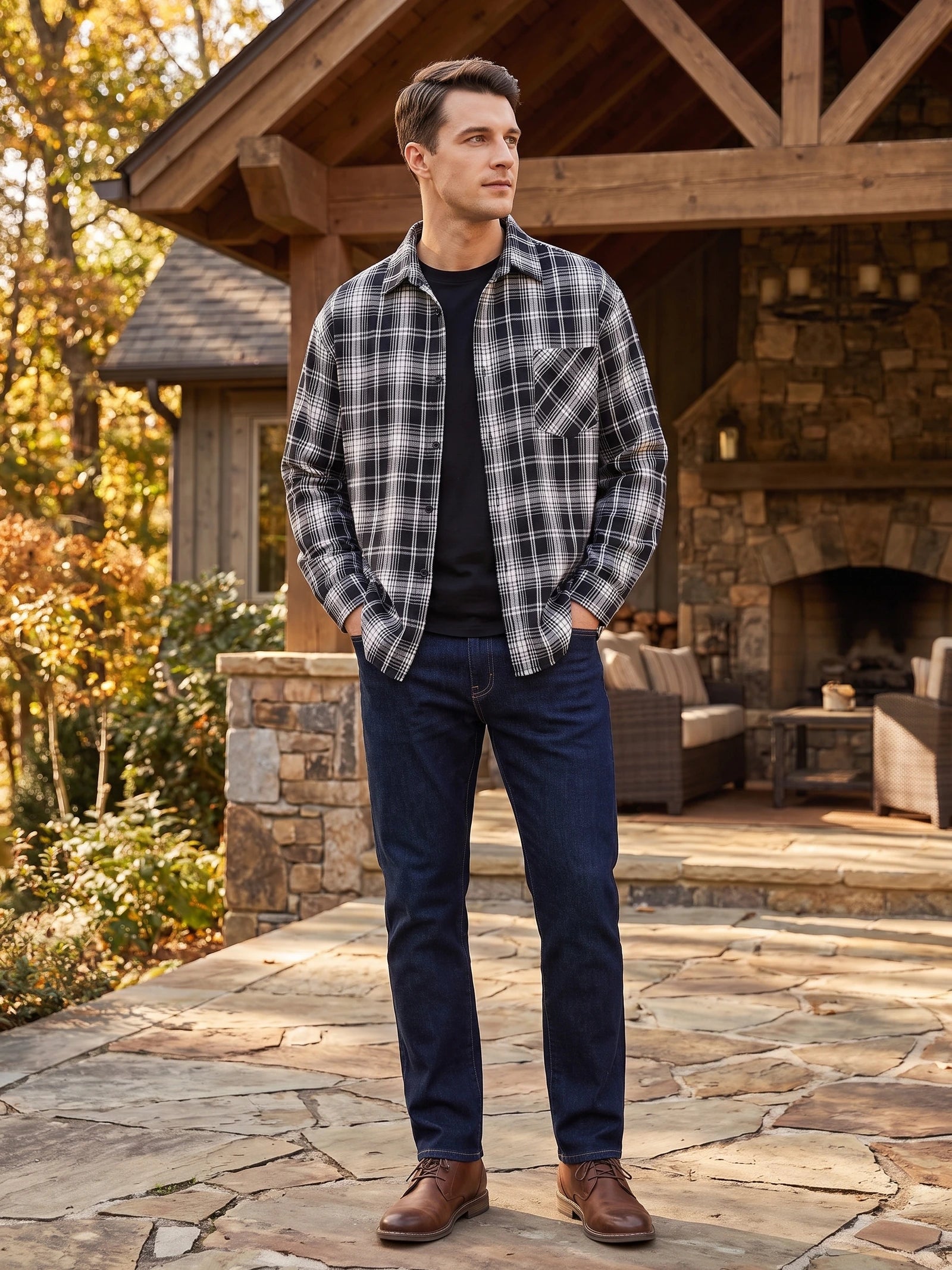 Man wearing a Black plaid Flannel Shirt with a chest pocket outside a rustic cabin.