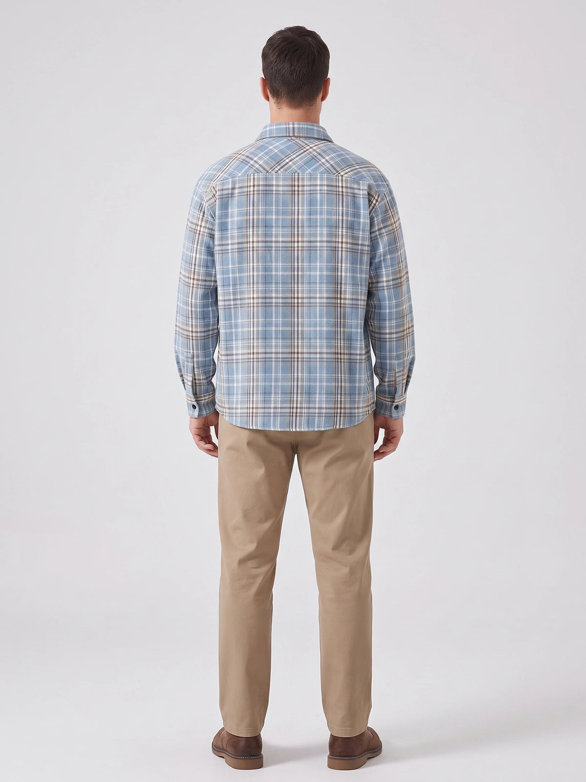 Rear studio view of a model wearing a Blue plaid long-sleeve Flannel Shirt.