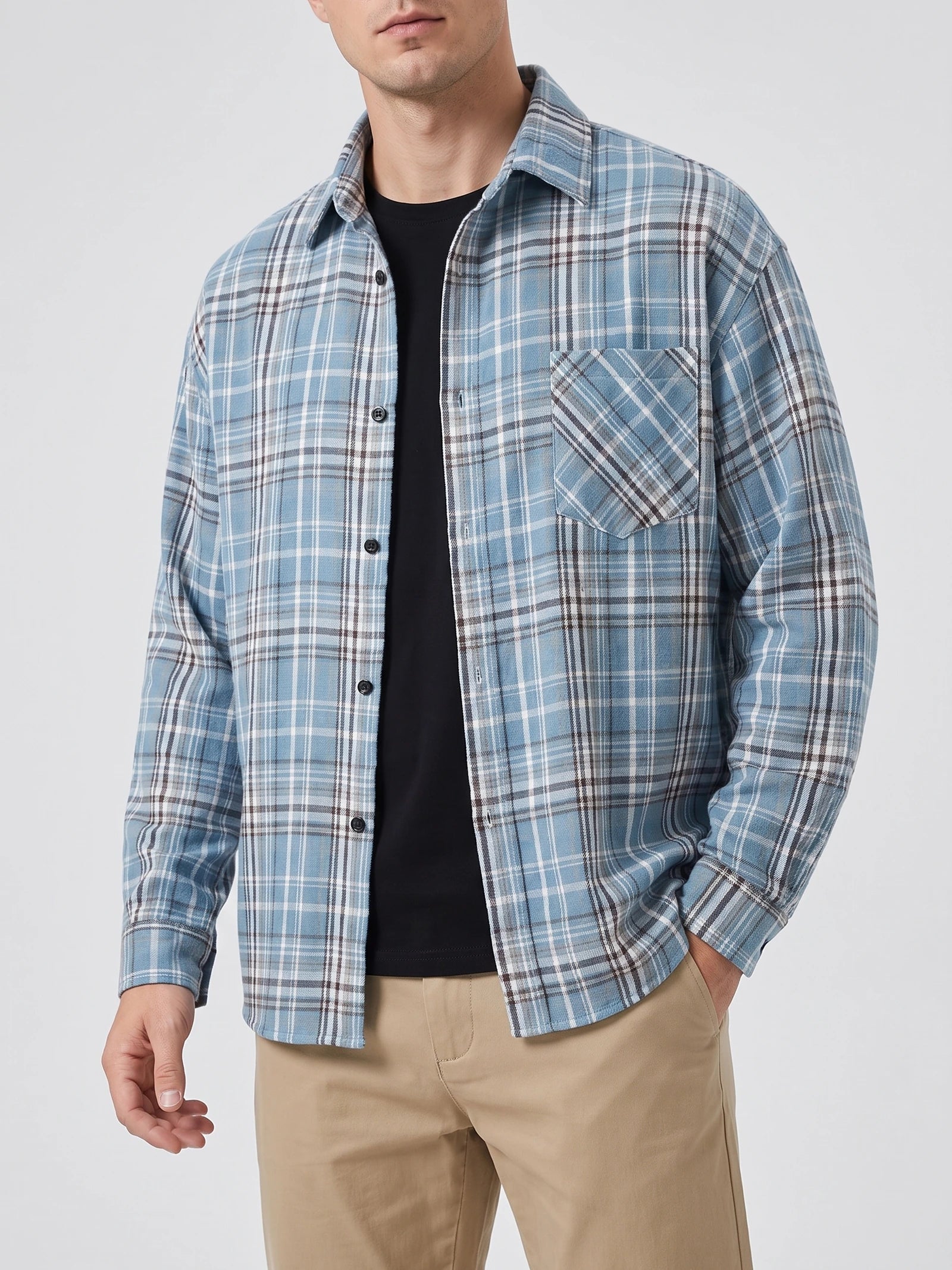 Front studio view of a model wearing a Blue plaid Flannel Shirt with long sleeves, button front, and chest pocket.