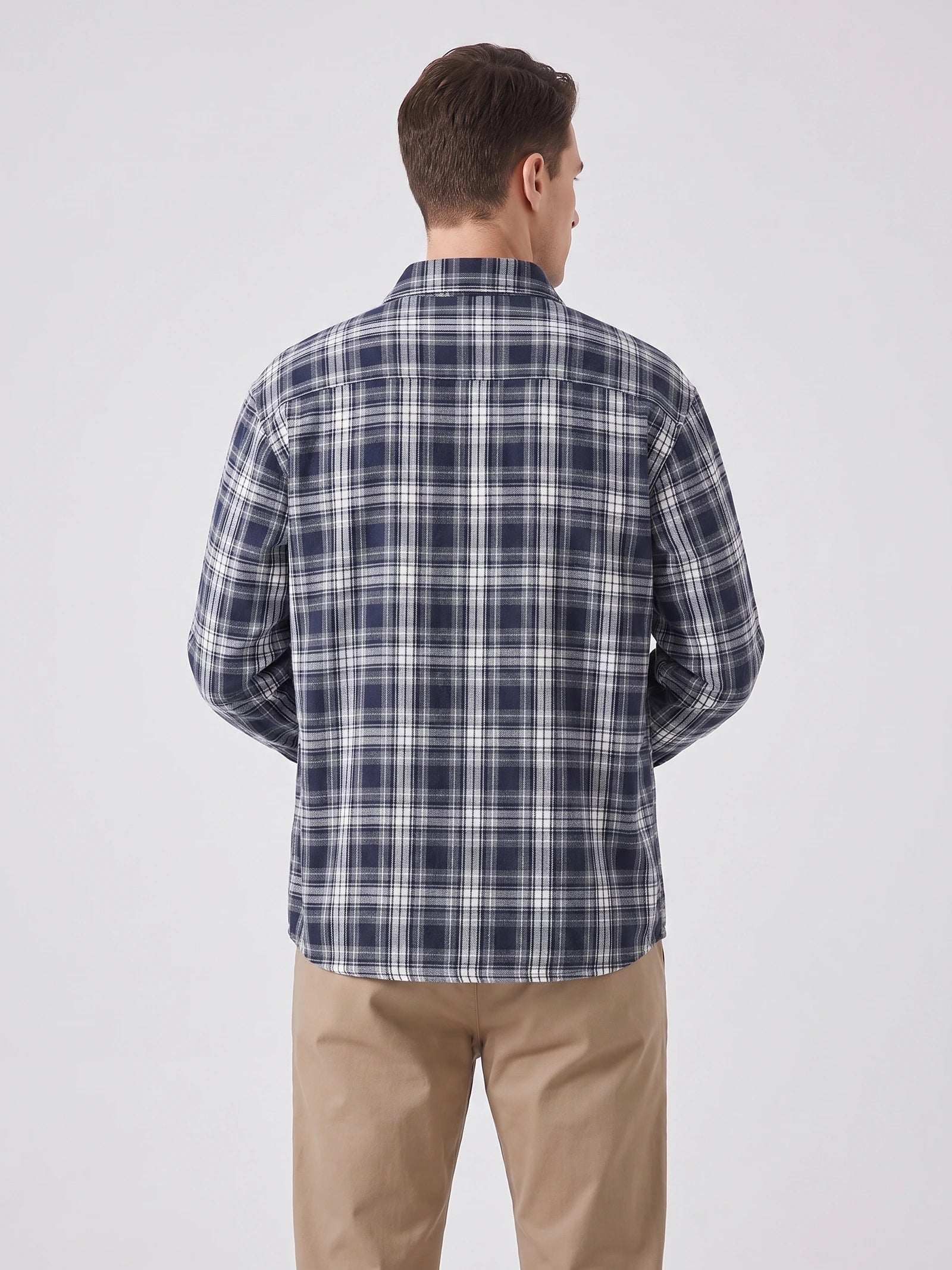 Rear view of a model wearing a Navy plaid long-sleeve Flannel Shirt, showing the back yoke and relaxed fit.