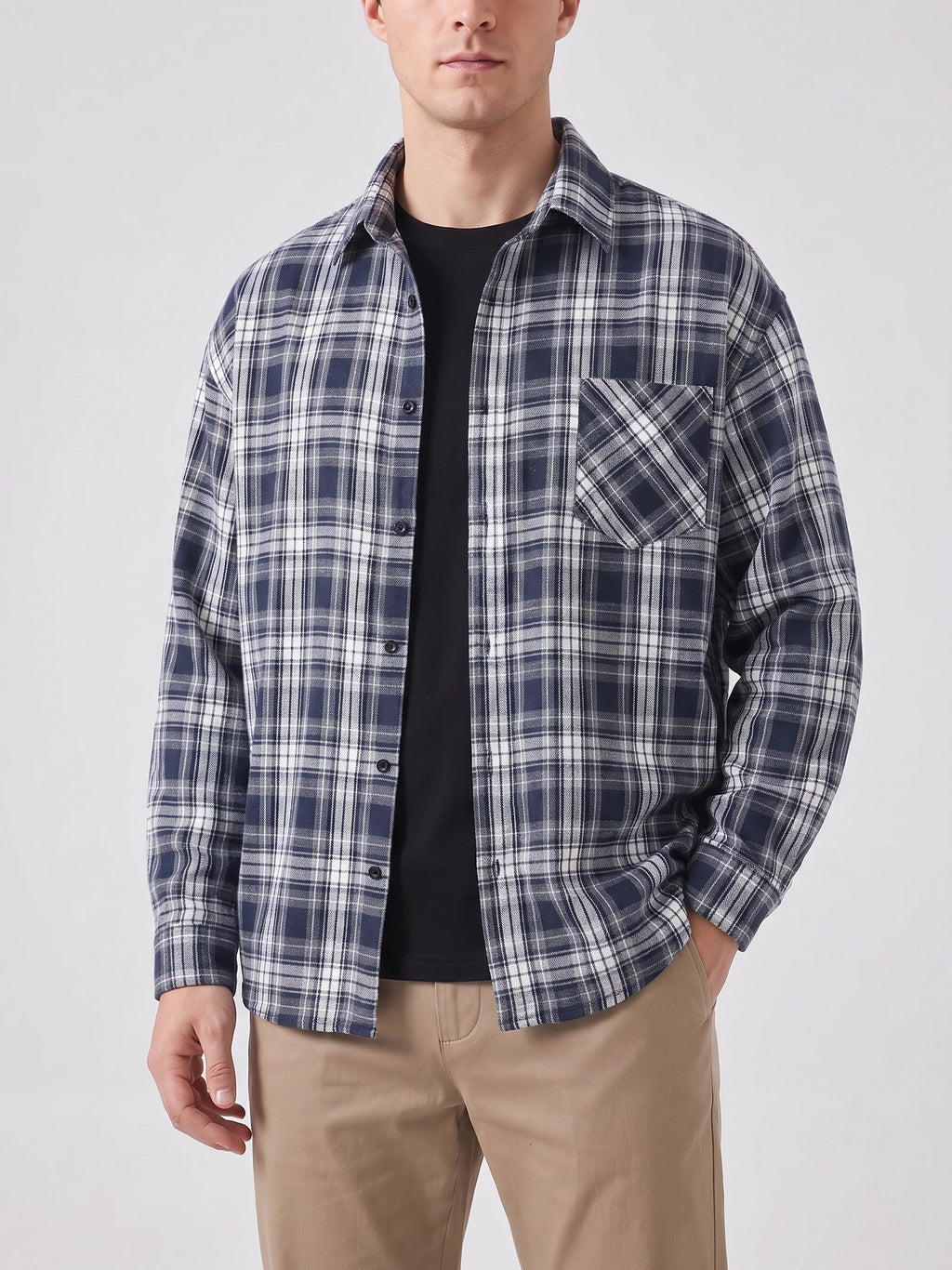 Front studio view of a model wearing a Navy plaid Flannel Shirt with long sleeves, button front, and chest pocket.