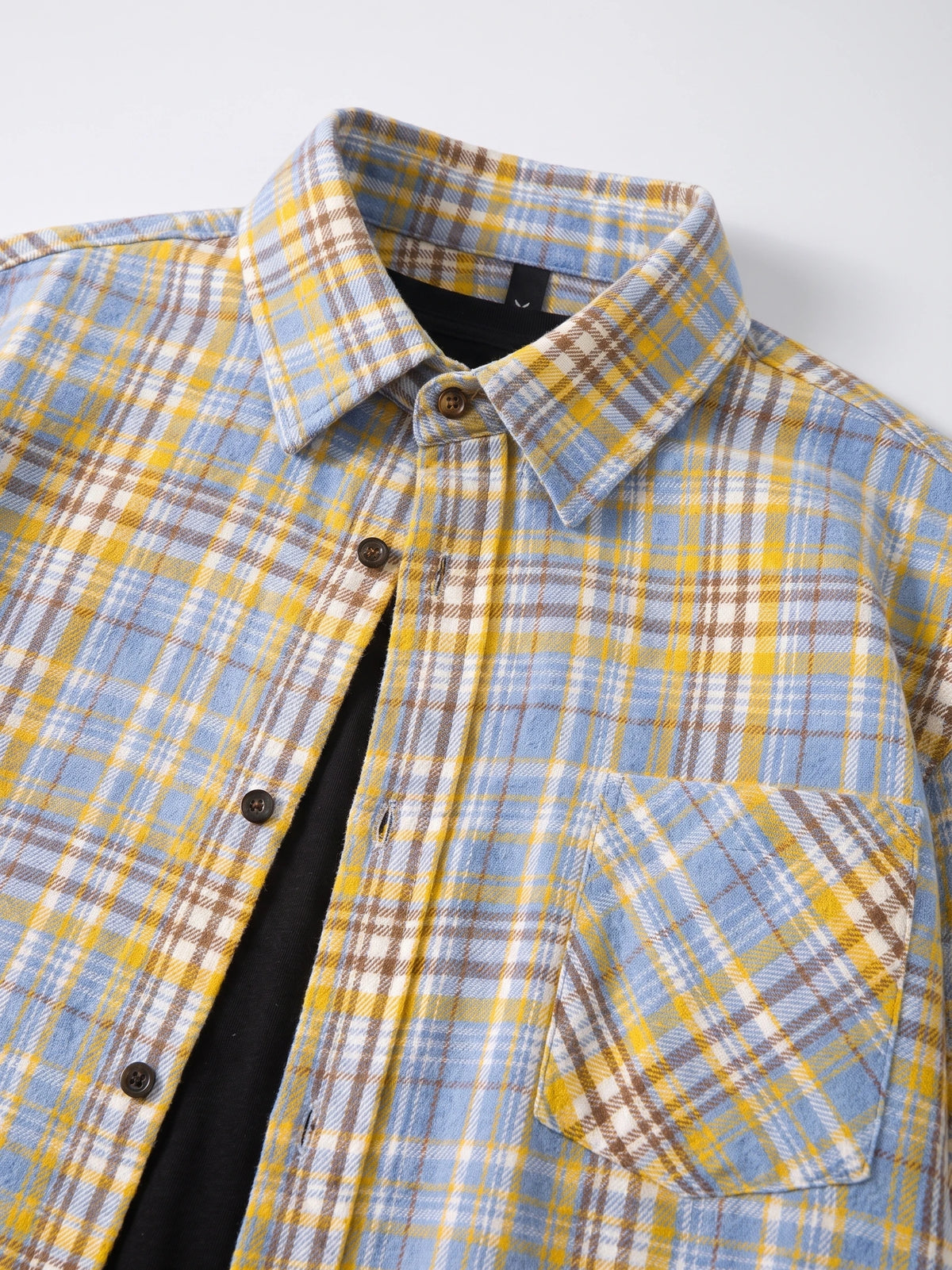 Close-up of the Yellow plaid Flannel Shirt showing the pointed collar, button front, and chest pocket.