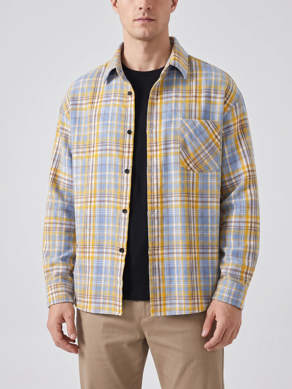 Front studio view of a model wearing a Yellow plaid Flannel Shirt with long sleeves, button front, and chest pocket.