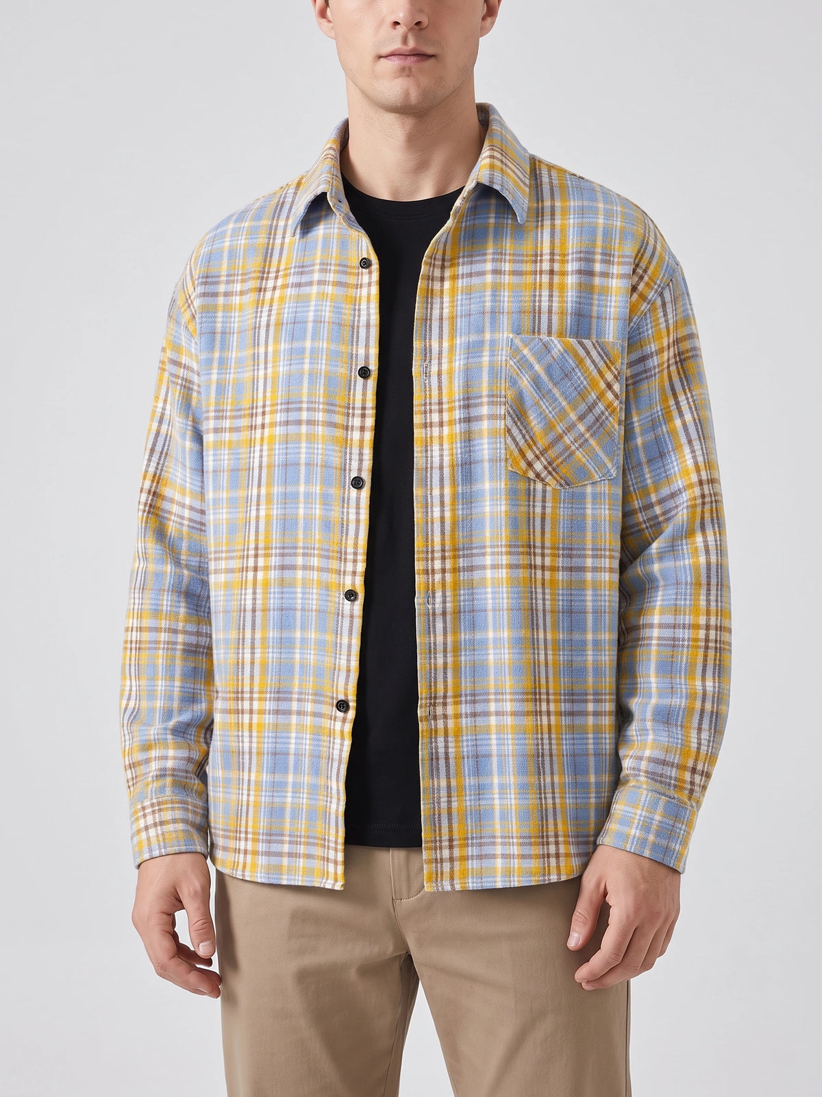 Front studio view of a model wearing a Yellow plaid Flannel Shirt with long sleeves, button front, and chest pocket.