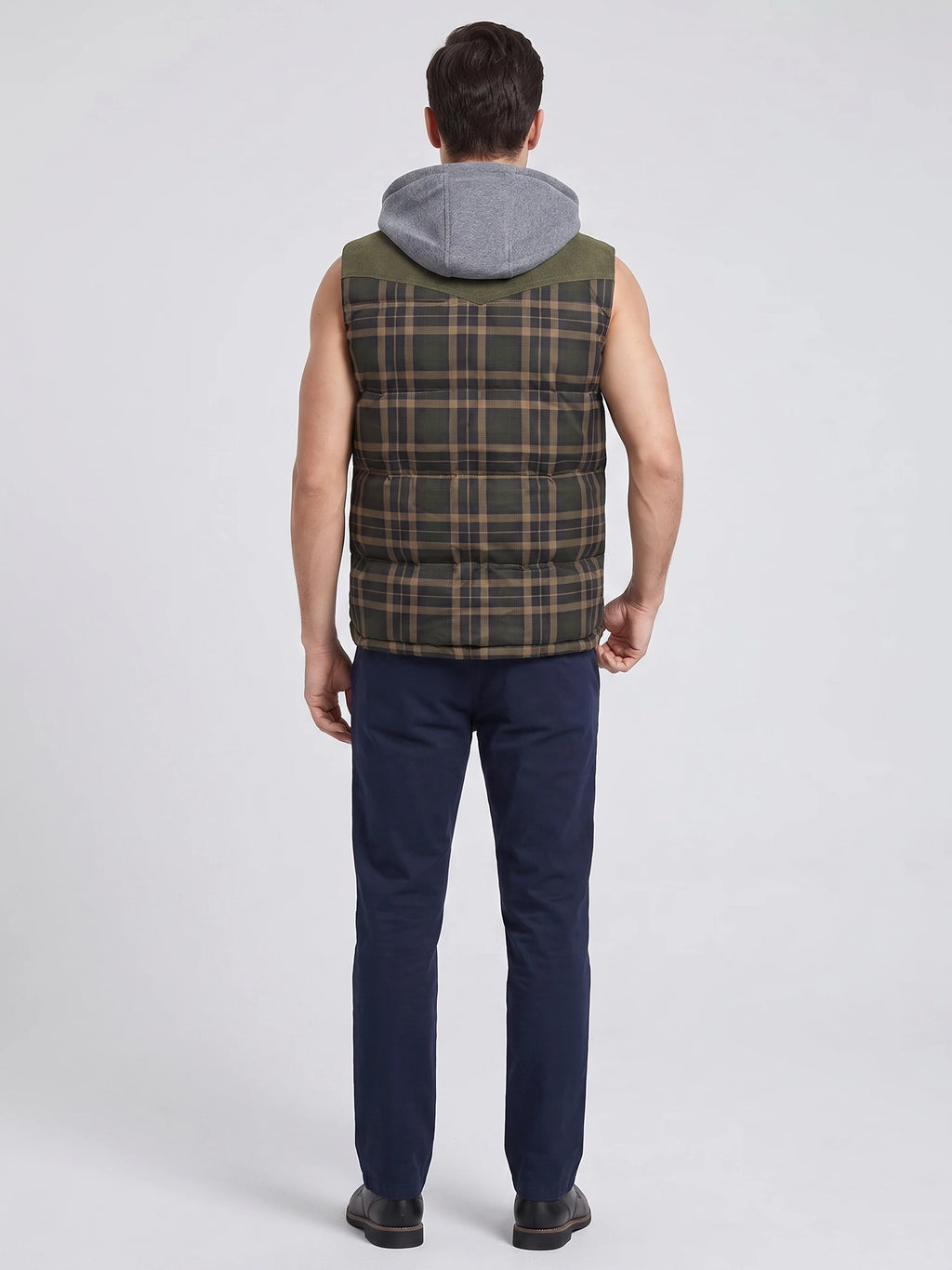 Rear studio view of a model wearing a Green plaid Puffer Vest with a hood and horizontal quilted panels.