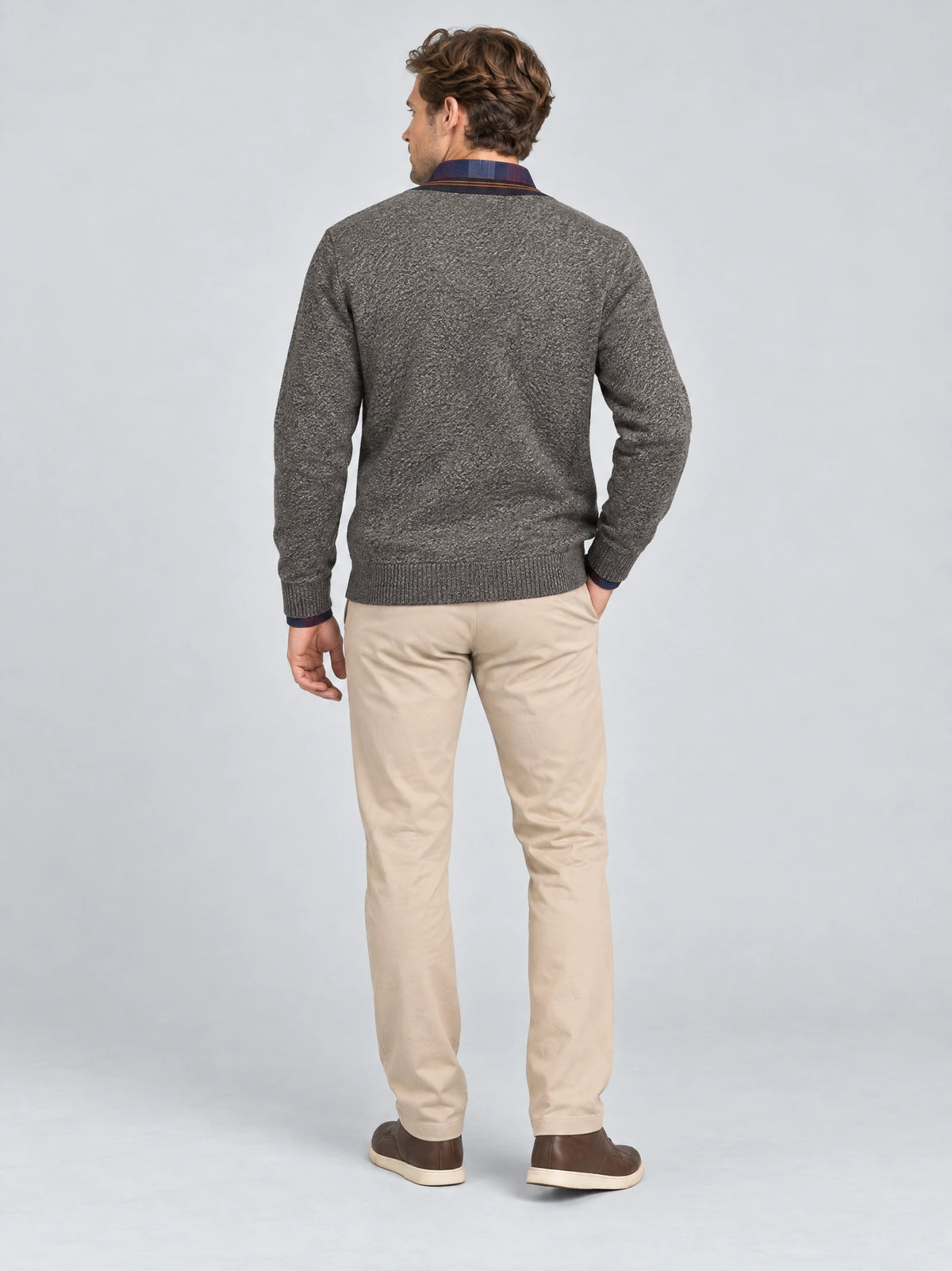 Rear studio view of a model wearing the Brown men's Sweater Pullover with ribbed cuffs and hem.