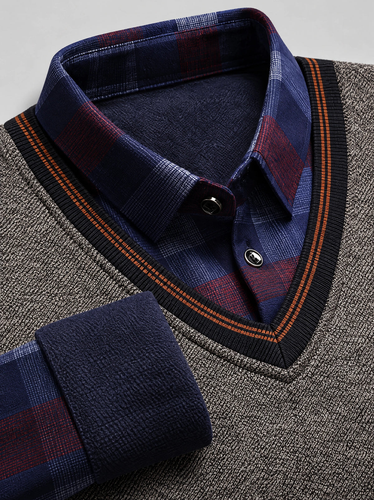Close-up of the Brown men’s sweater pullover with textured knit, a striped ribbed V-neck, and cuff detail.