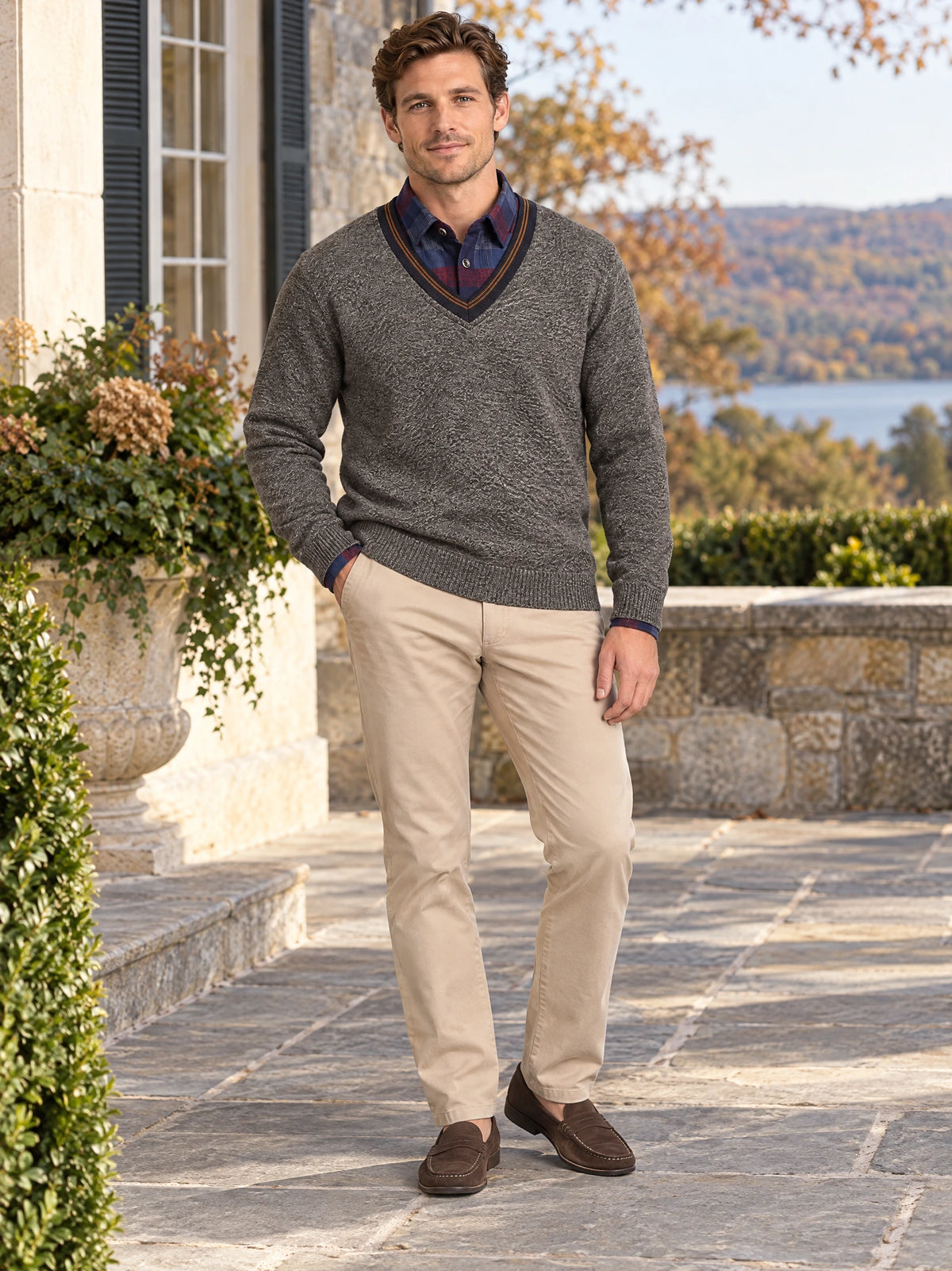 Model wearing a Brown textured V-neck sweater pullover on a stone patio beside an autumn garden.