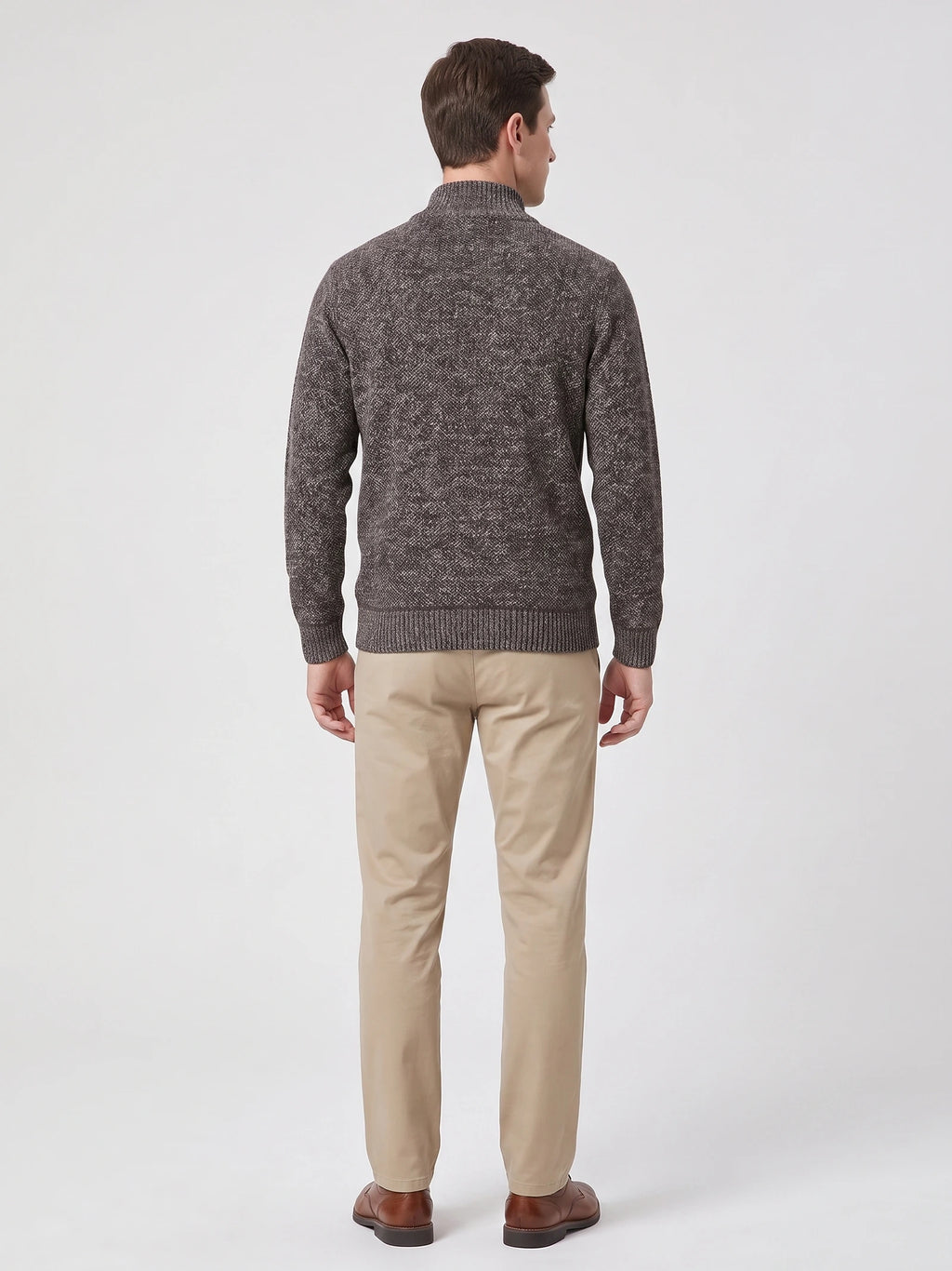 Back view of a model wearing a Brown quarter zip sweater with a ribbed mock neck, cuffs, and hem.