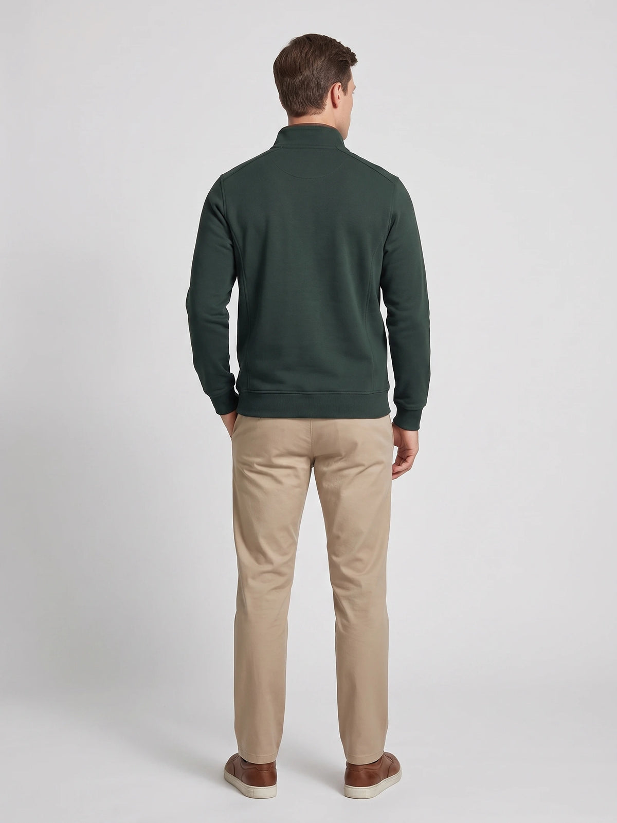 Rear studio view of a model wearing the Green Quarter Zip Sweater with a stand collar, long sleeves, and ribbed cuffs and hem.