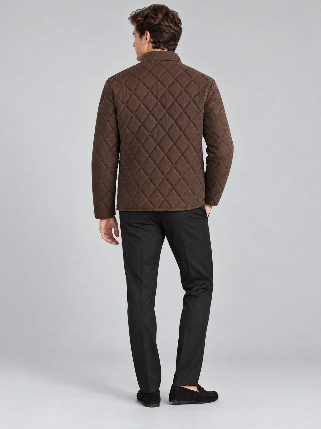 Rear studio view of a model wearing a Brown Quilted Field Jacket with diamond-pattern stitching and a stand collar.
