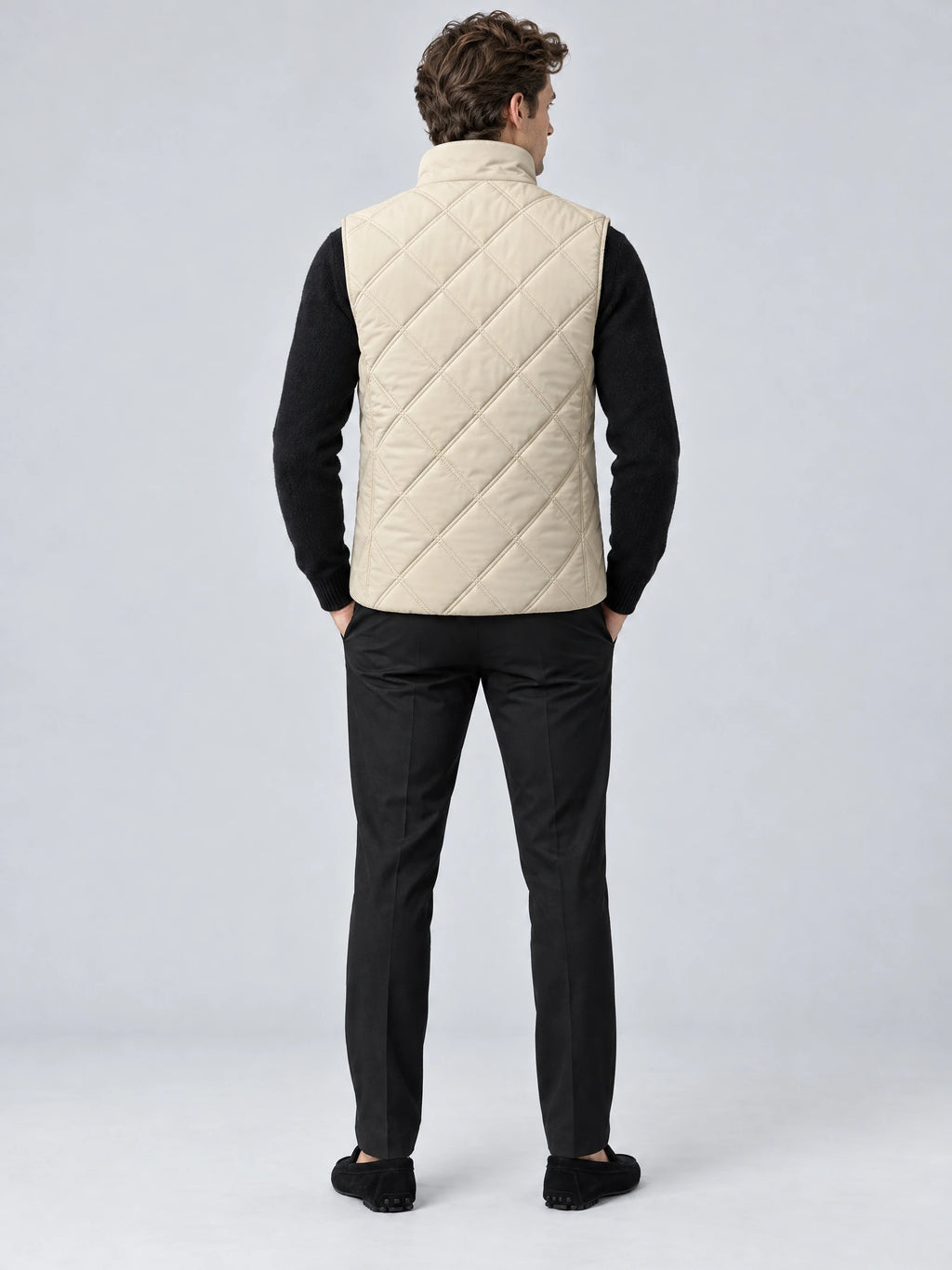 Back view of a model wearing a Beige Quilted Puffer Vest with diamond stitching and a stand collar.