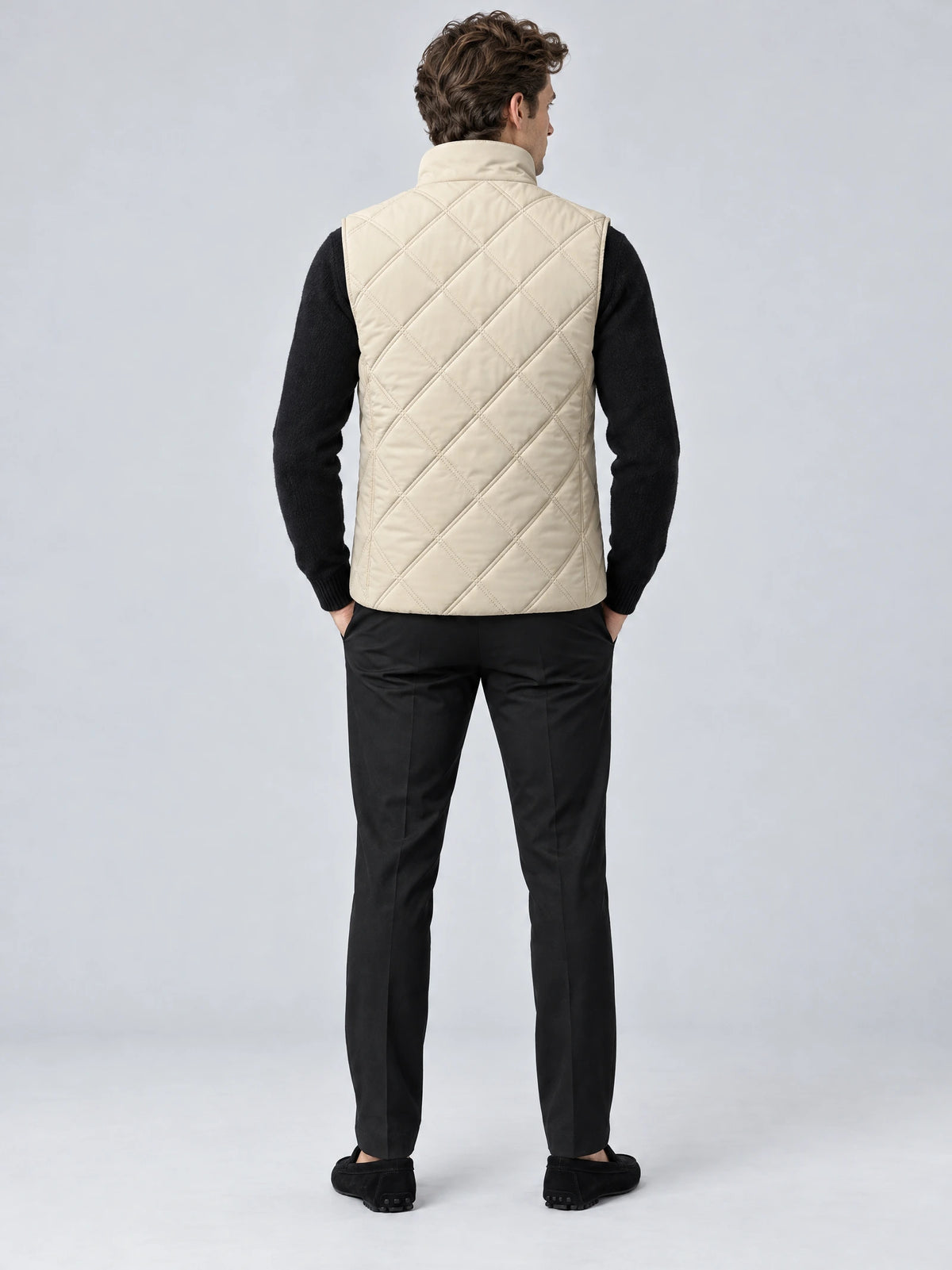 Back view of a model wearing a Beige Quilted Puffer Vest with diamond stitching and a stand collar.
