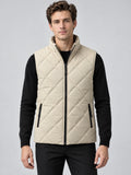 Front studio view of a model wearing a Beige Quilted Puffer Vest with diamond stitching, a zip front, and zippered pockets.