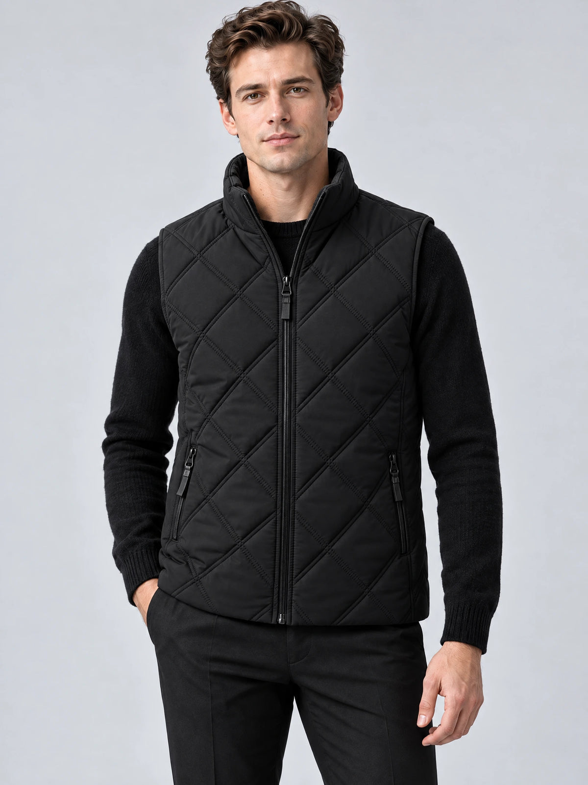Front studio view of a model wearing a Black Quilted Puffer Vest with diamond quilting, zip front, stand collar, and zip pockets.