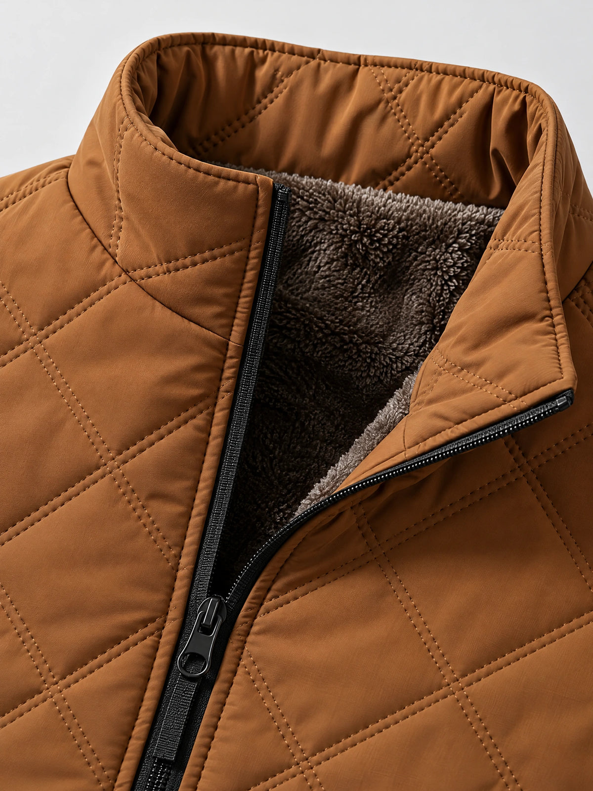 Close-up of the Brown Quilted Puffer Vest showing the stand collar, front zipper, diamond stitching, and soft fleece lining.