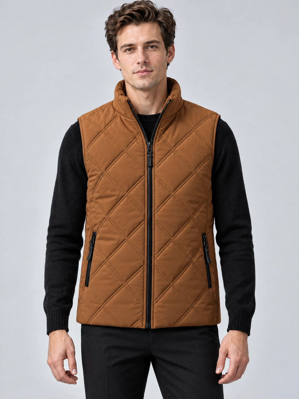 Front studio view of a model wearing a Brown Quilted Puffer Vest with a stand collar, full zip closure, and zip pockets.