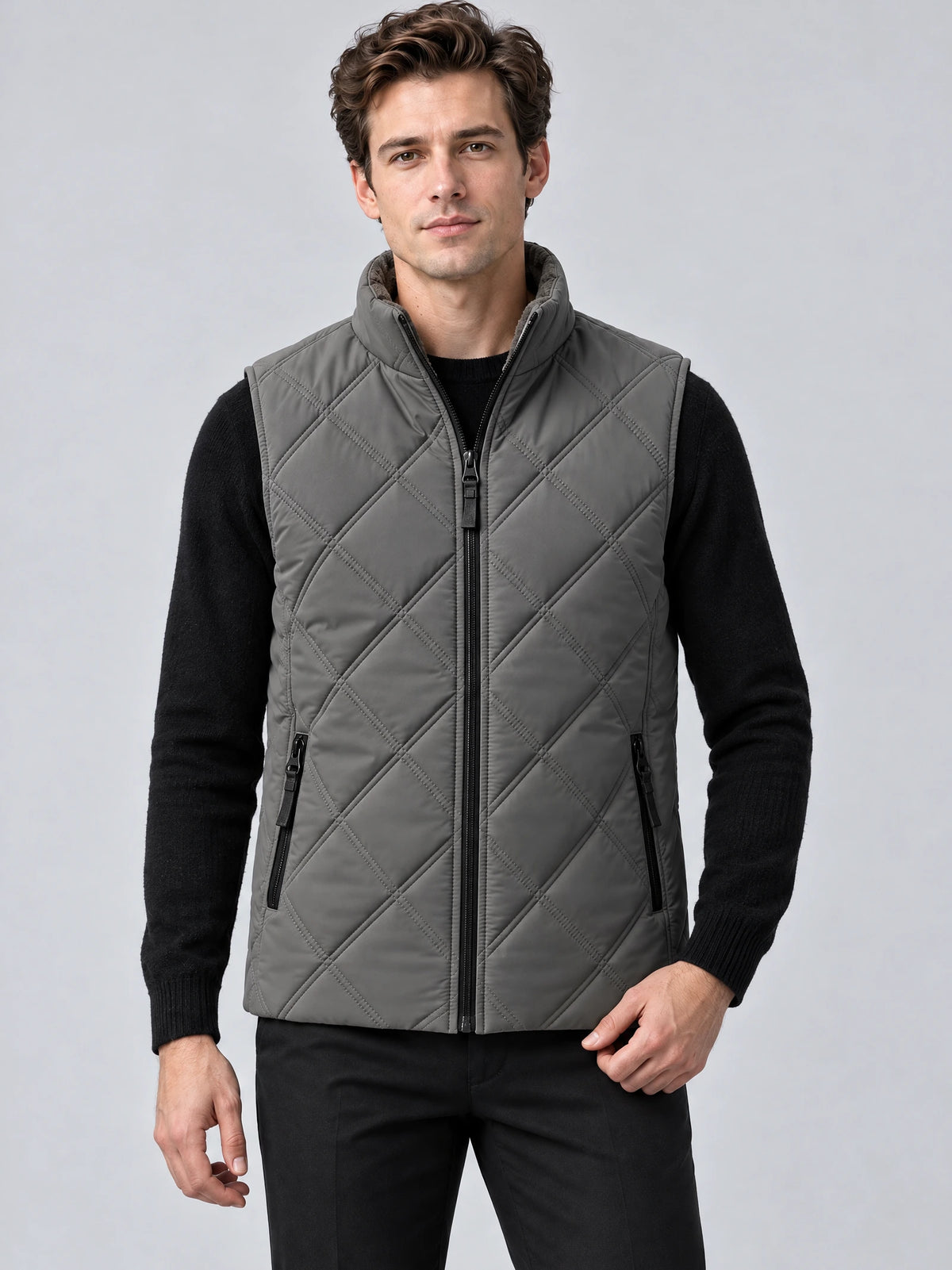 Front studio view of a model wearing a Gray quilted puffer vest with a stand collar, zip front, and zippered pockets.