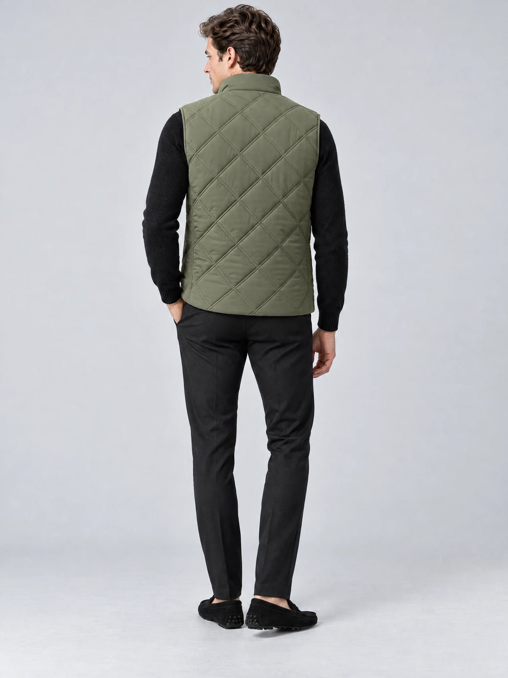 Rear studio view of a model wearing a Green Quilted Puffer Vest with diamond stitching and a stand collar.