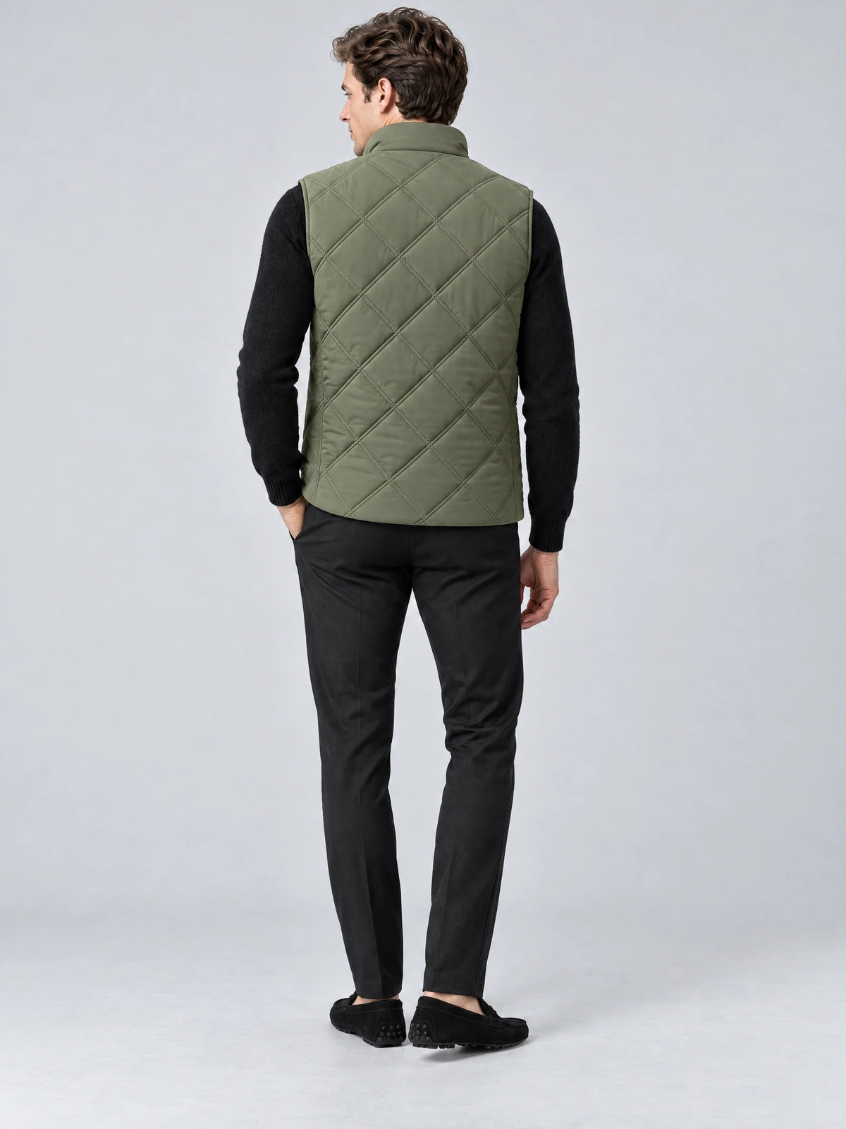 Rear studio view of a model wearing a Green Quilted Puffer Vest with diamond stitching and a stand collar.