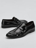 Black ruched leather loafers shown as a pair in a studio product photo, featuring slip-on straps and gathered toe detailing.