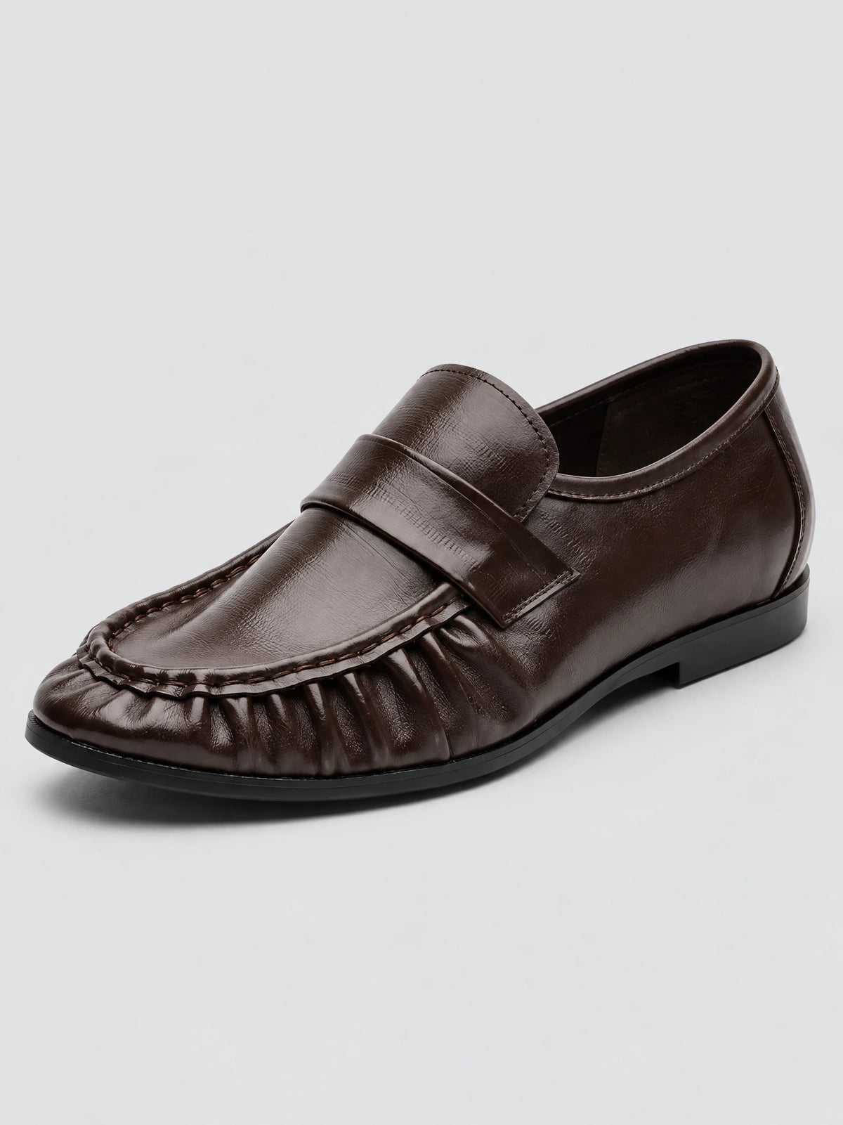 Three-quarter view of Brown ruched leather loafers with a stitched moc toe and wide penny strap.