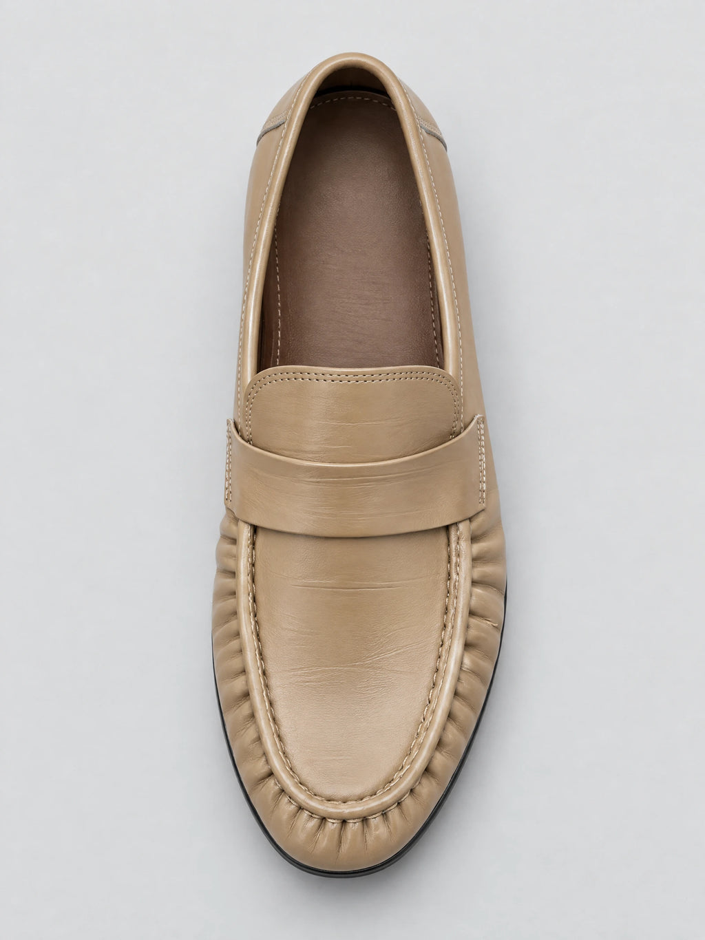 Top-down close-up of a Khaki Ruched Leather Loafer with a wide strap and gathered stitched toe.