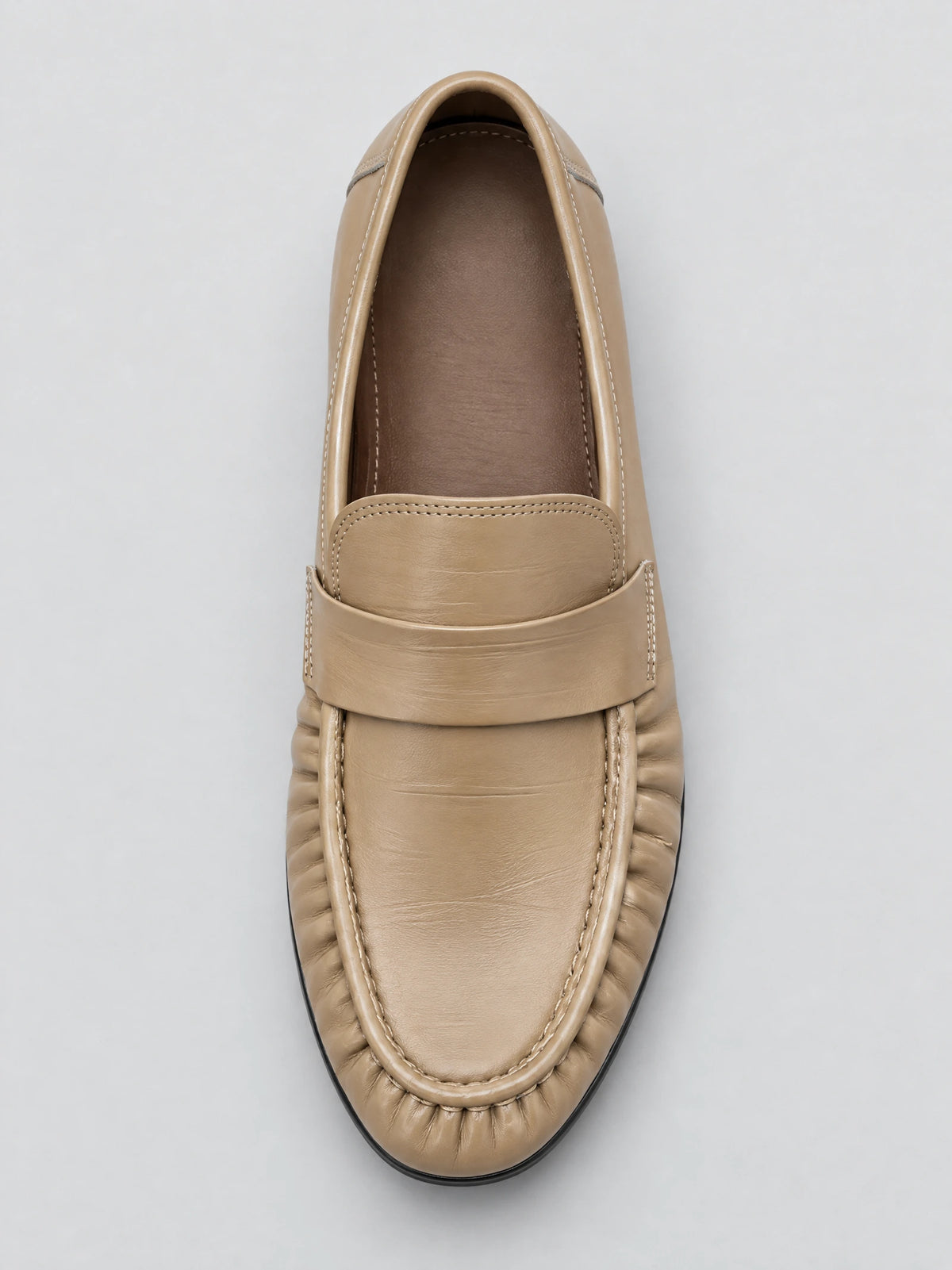 Top-down close-up of a Khaki Ruched Leather Loafer with a wide strap and gathered stitched toe.