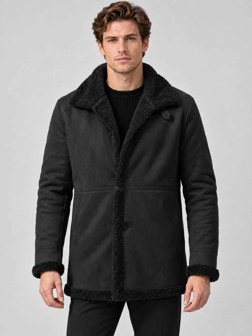 Front studio view of a model wearing a Black Sherpa-lined jacket with a wide collar, button closure, and trim at the cuffs and hem.