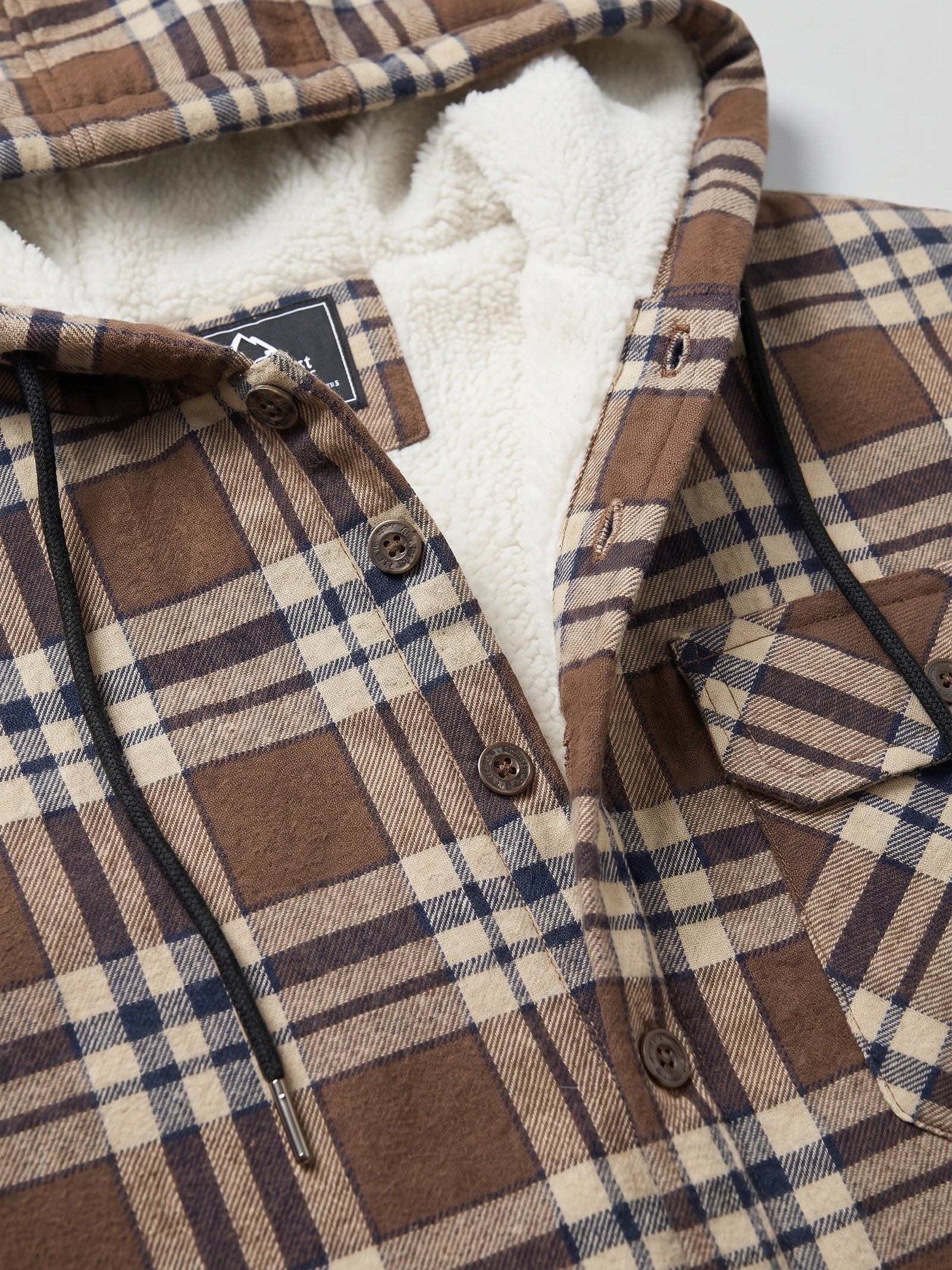 Close-up of the Brown Sherpa Lined Jacket showing its hood, soft lining, button-front placket, drawcord, and chest pocket.