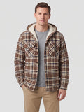 Front studio view of a model wearing a Brown plaid Sherpa Lined Jacket with a hood, button front, and chest pockets.