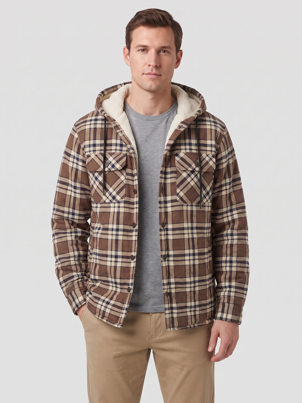Front studio view of a model wearing a Brown plaid Sherpa Lined Jacket with a hood, button front, and chest pockets.