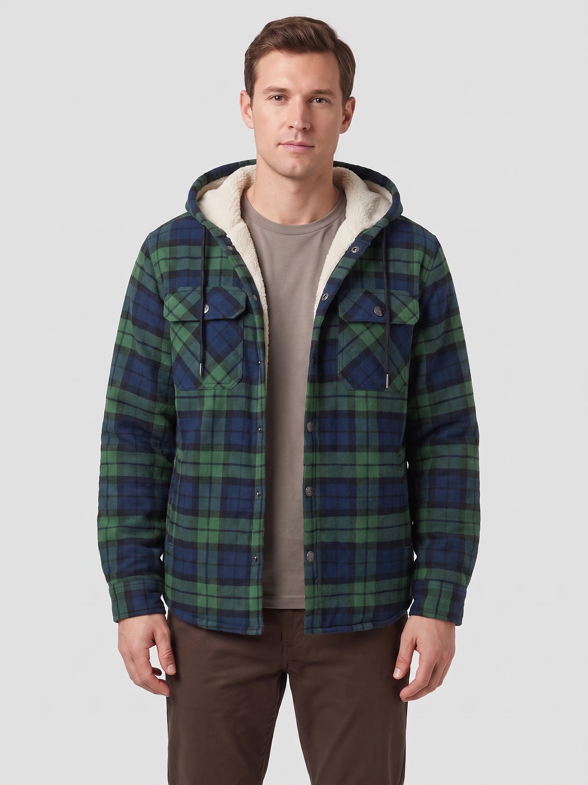 Front studio view of a model wearing a Green Sherpa Lined Jacket with a hood, plaid pattern, button front, and chest flap pockets.