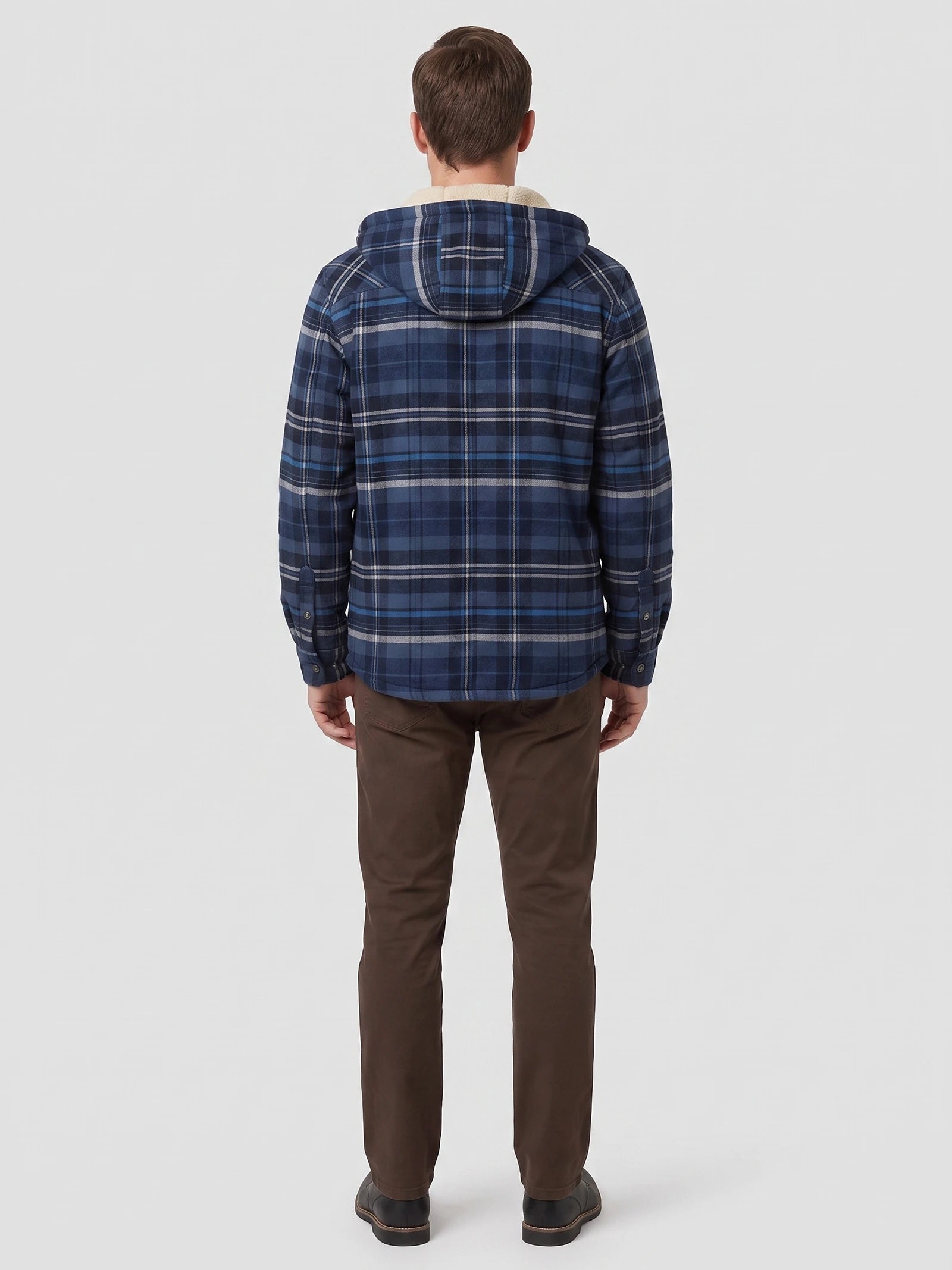 Rear view of a model wearing a Navy Sherpa Lined Jacket with a plaid pattern, hood, and button cuffs.