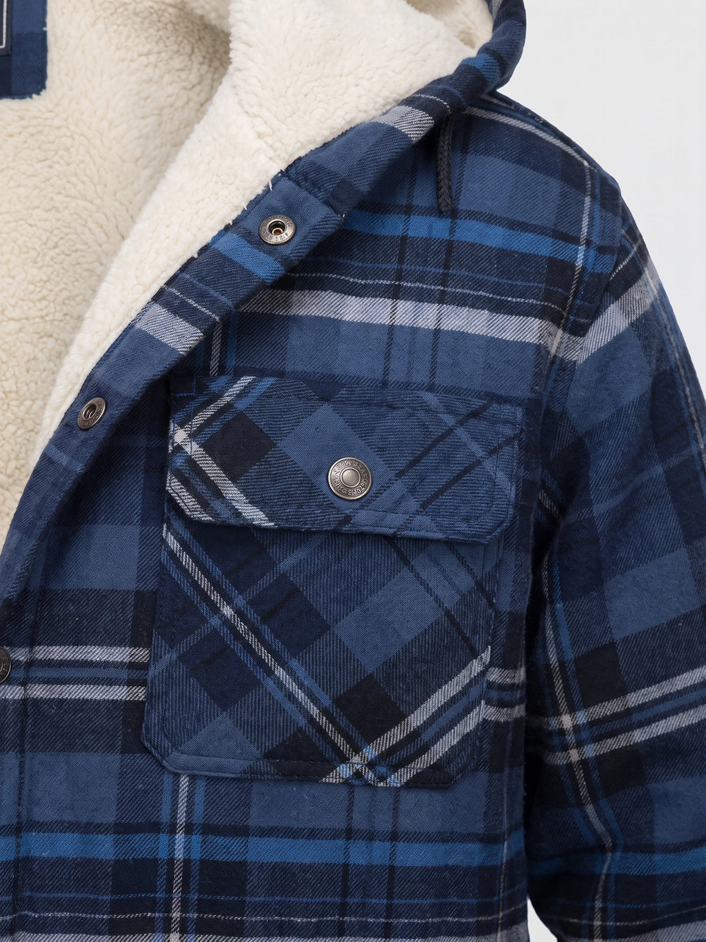 Close-up of the Navy Sherpa Lined Jacket showing the plush lining, plaid fabric, snap-button front, and flap chest pocket.