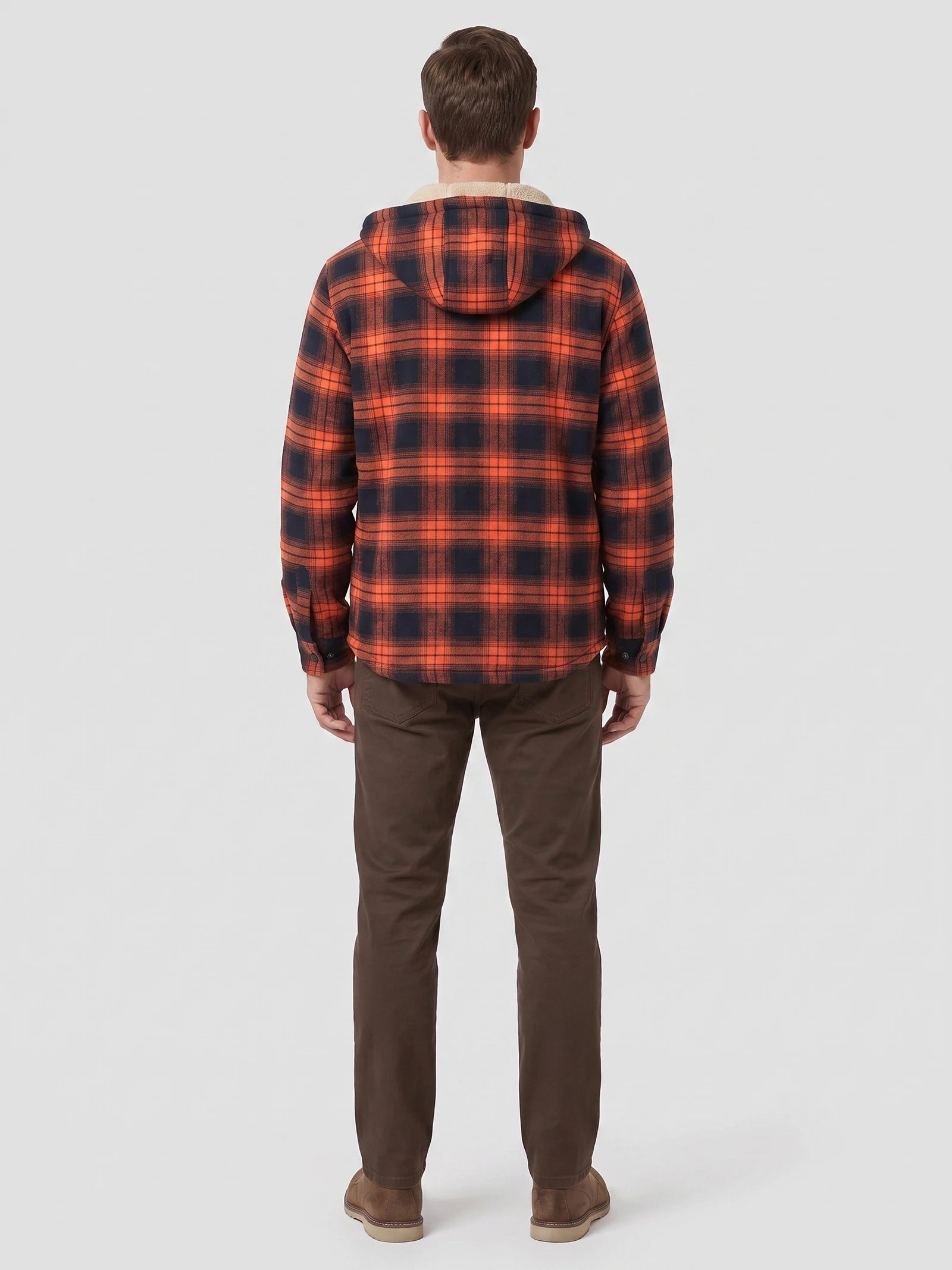 Rear view of a model wearing an Orange plaid Sherpa Lined Jacket with a hood in a studio.