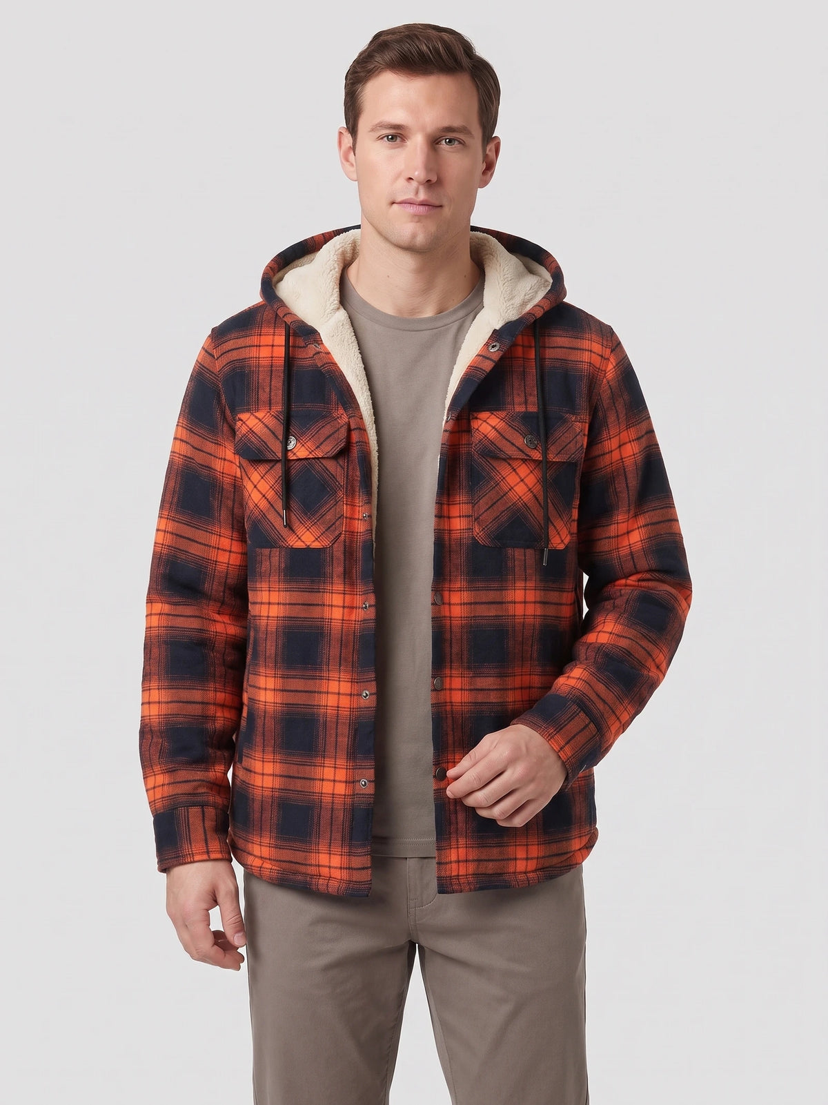 Front studio view of a model wearing an Orange plaid Sherpa Lined Jacket with a hood, button front, and flap chest pockets.