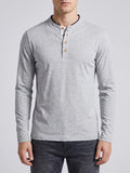 Front studio view of a model wearing a Gray Slim-Fit cotton long-sleeve Henley shirt with a button placket.