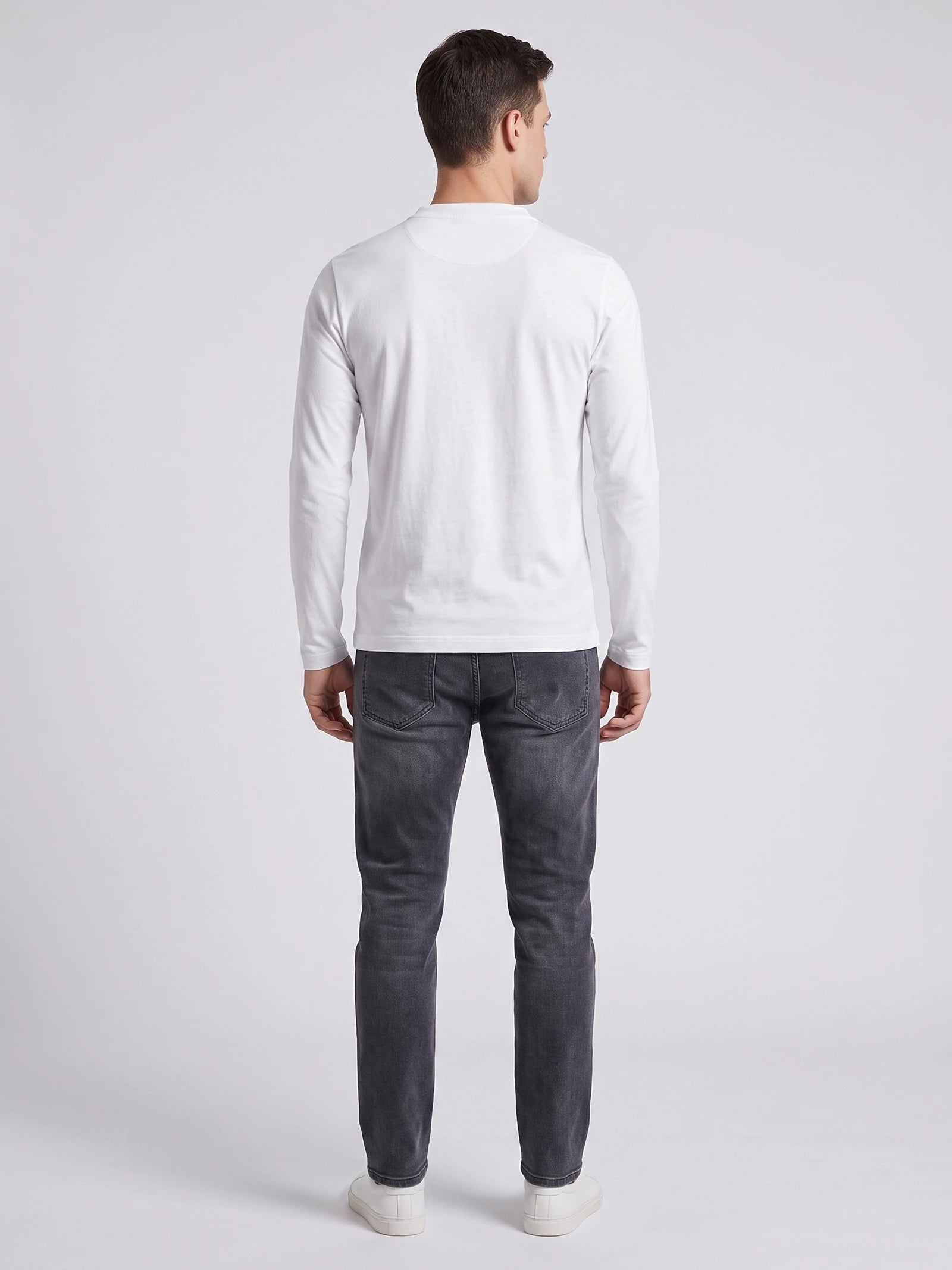 Rear studio view of a model wearing the White Slim-Fit cotton long-sleeve Henley shirt.