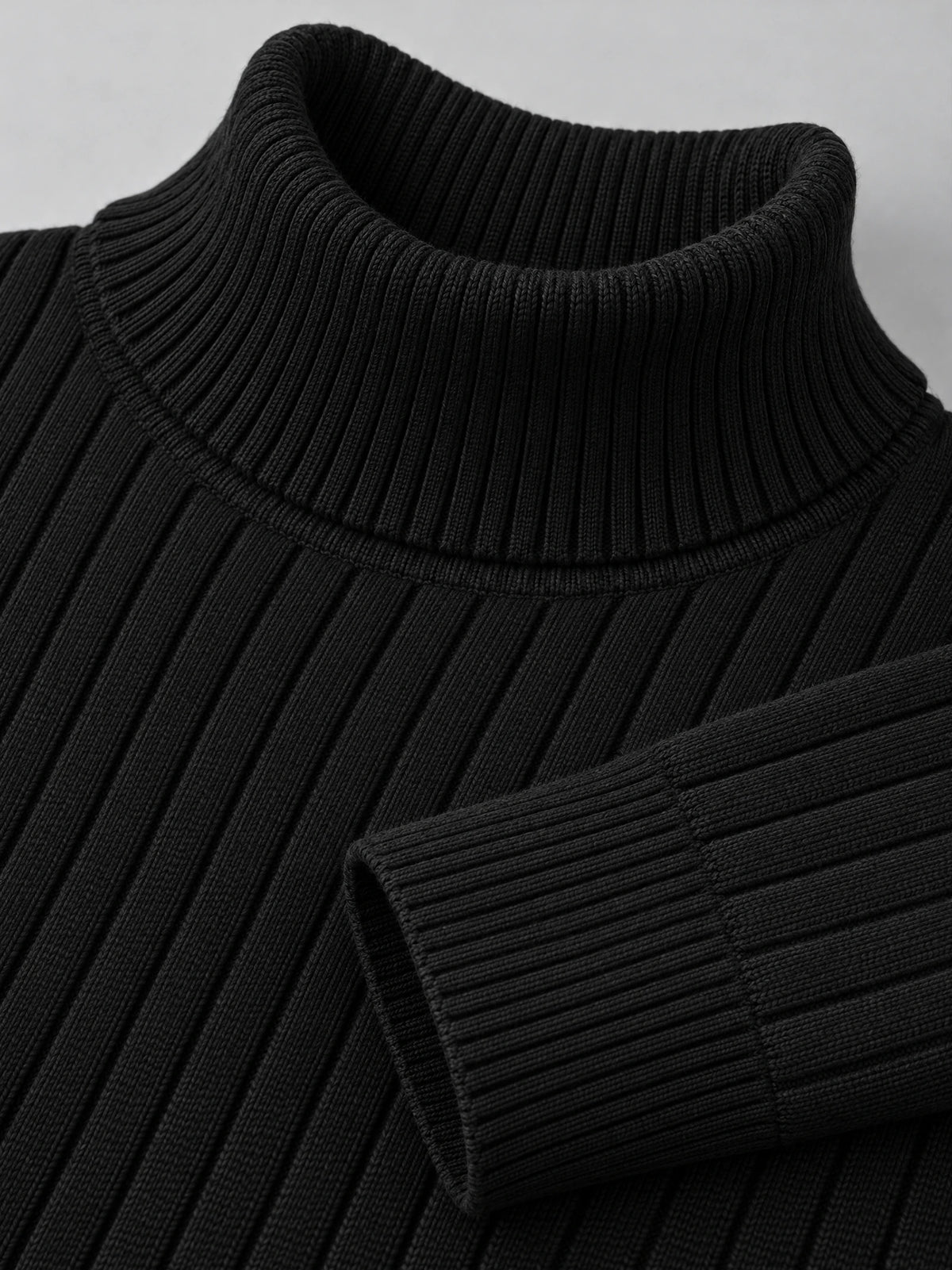 Close-up of the Black men’s Slim Fit Pullover Sweater showing its ribbed turtleneck knit texture and cuff.