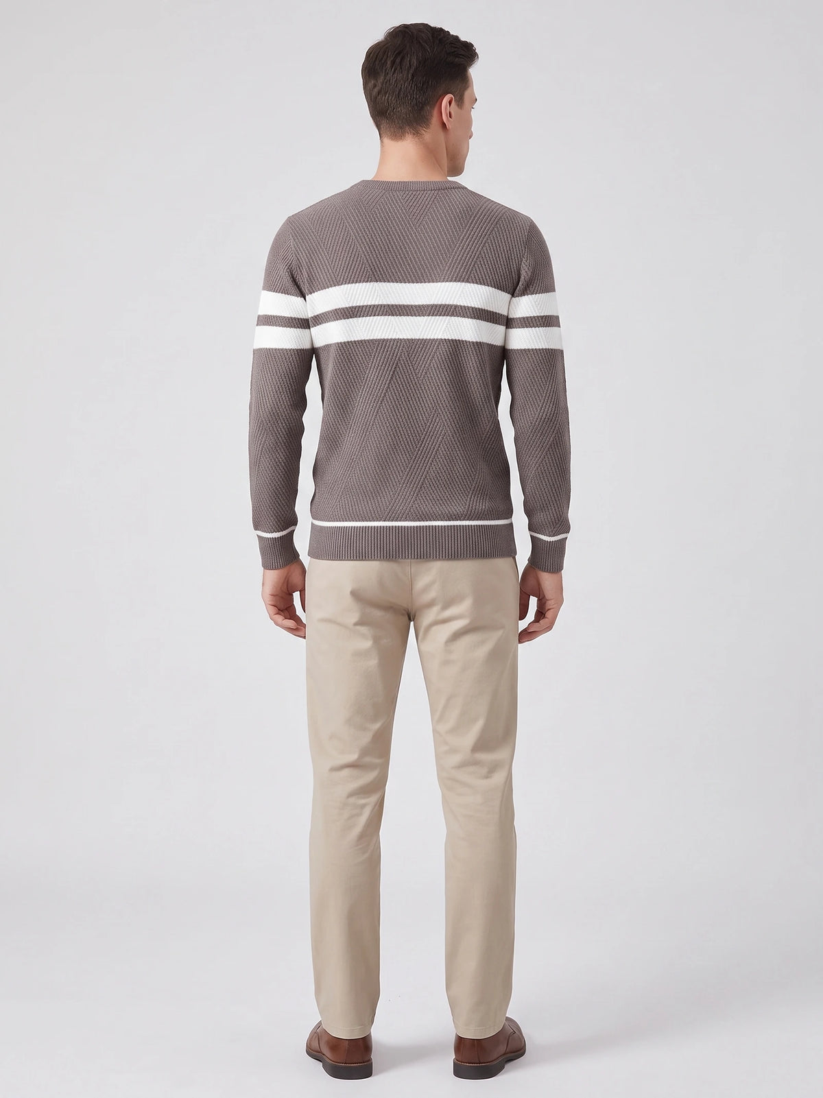 Rear studio view of a model wearing a Brown slim cotton crew neck sweater with textured knit panels and horizontal chest stripes.