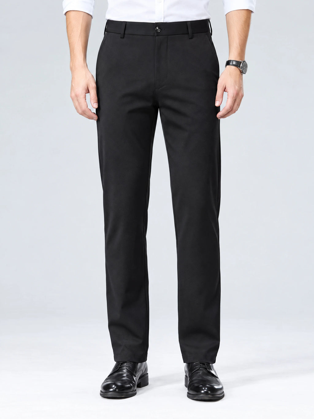 Front studio view of a model wearing Black men's straight-leg pants with a button waistband and side pockets.