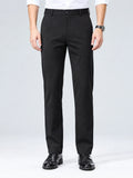 Front studio view of a model wearing Black men's straight-leg pants with a button waistband and side pockets.