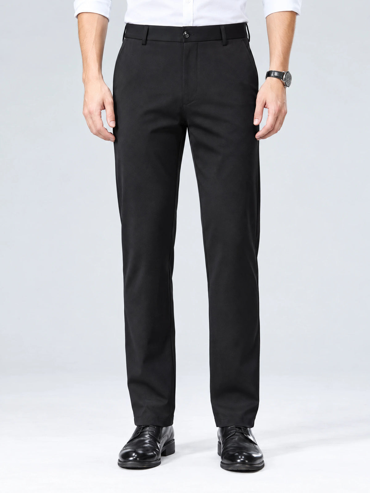 Front studio view of a model wearing Black men's straight-leg pants with a button waistband and side pockets.