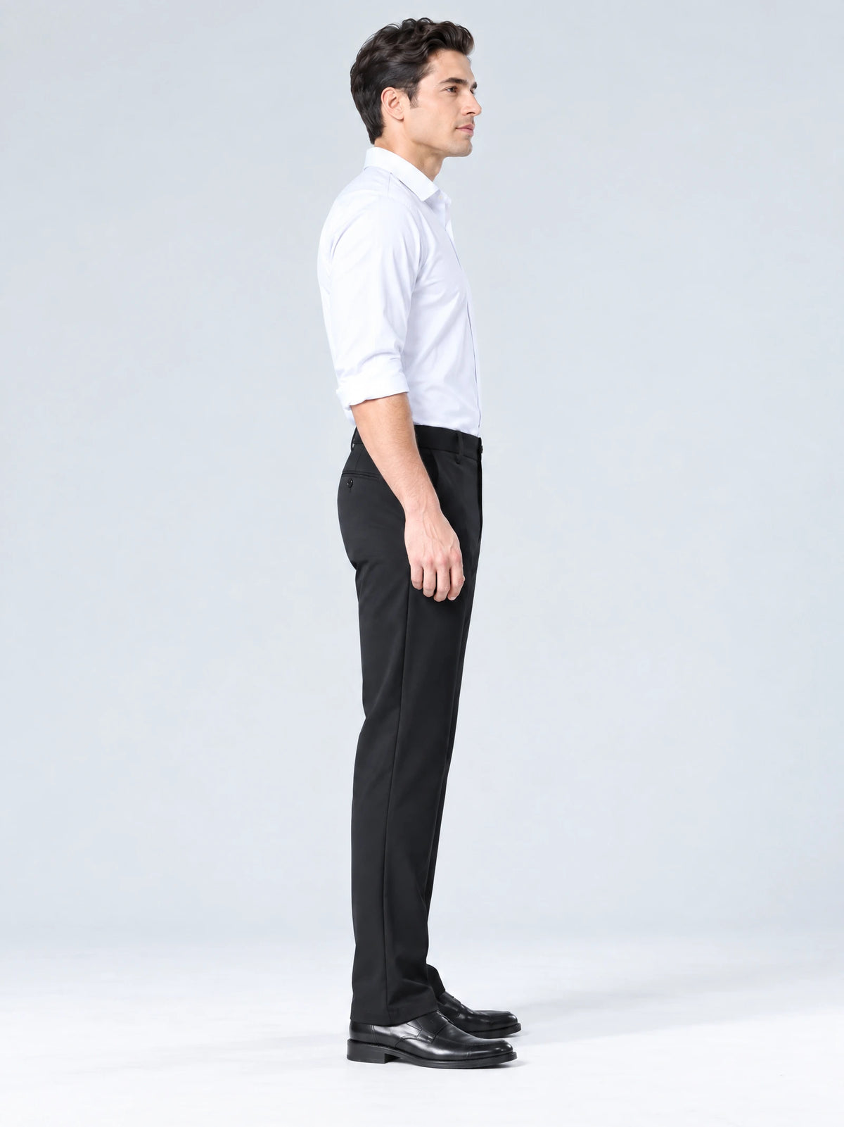 Side studio view of a model wearing Black men's straight-leg casual pants.