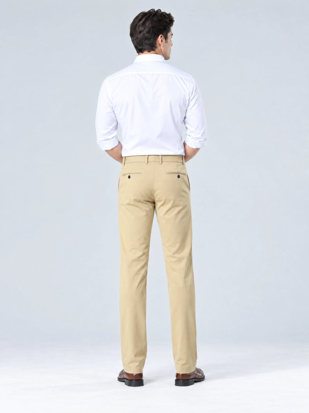 Rear studio view of a model wearing Khaki straight-fit men's pants with buttoned back welt pockets.